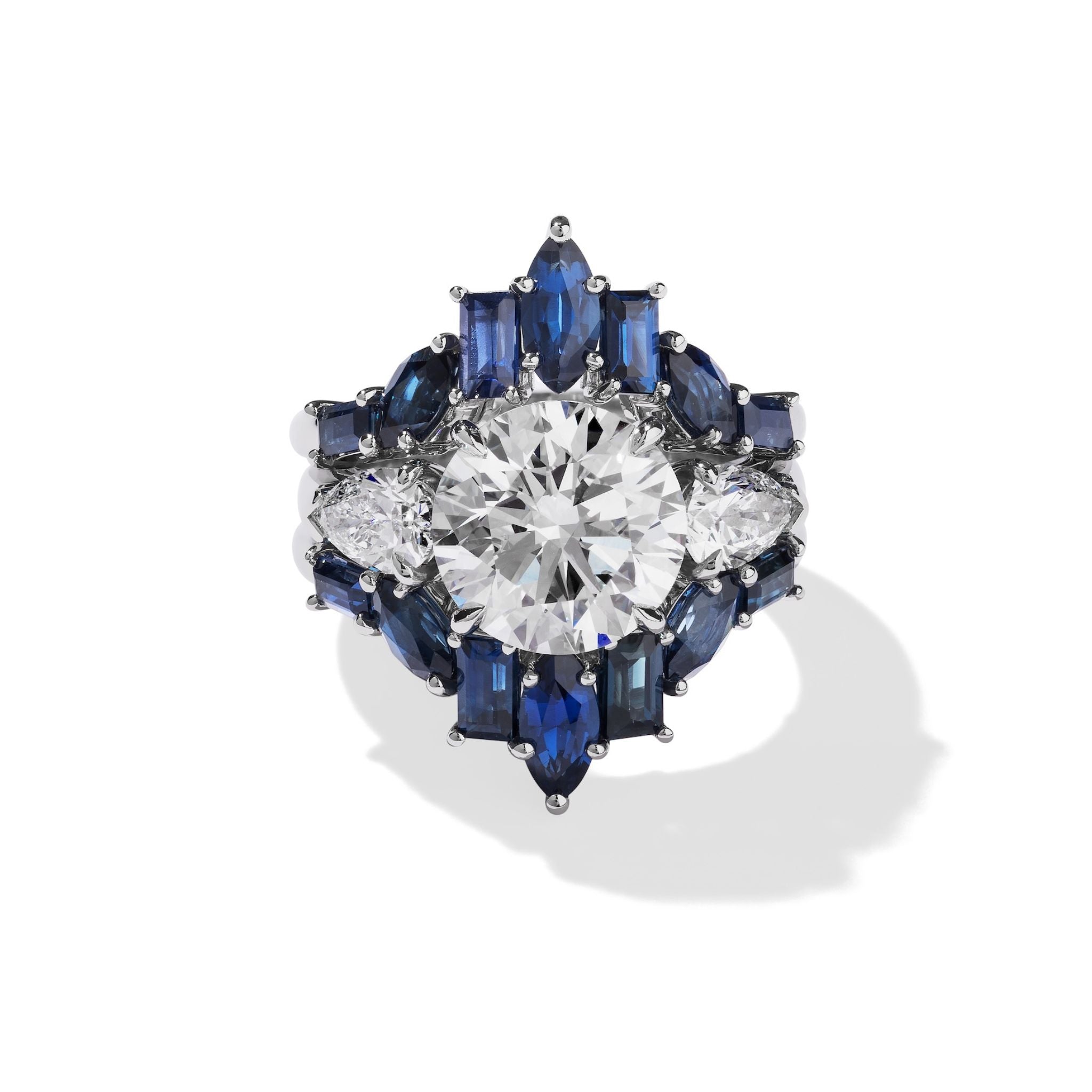 The Bespoke Baguette and Marquise Sapphire Engagement Ring Jacket in White Gold features striking baguette and marquise sapphires, designed to accentuate your ring with a bold, symmetrical sparkle that truly stands out.