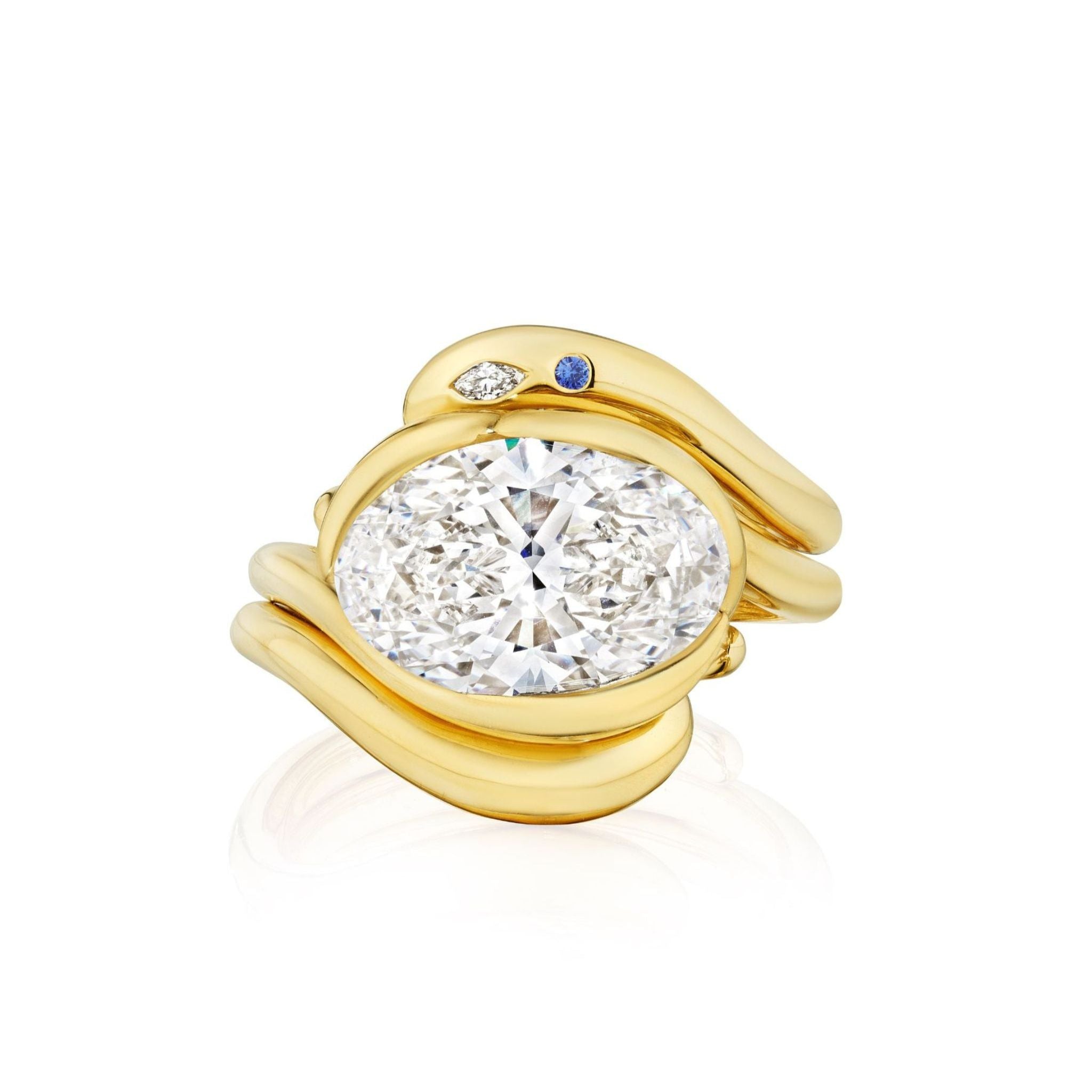 The Asymmetrical Wave Ring Jacket with Birthstone Accents in Yellow Gold features flowing double bands, an oval center diamond, and accents of a blue gemstone and white diamond for a unique, elegant look.