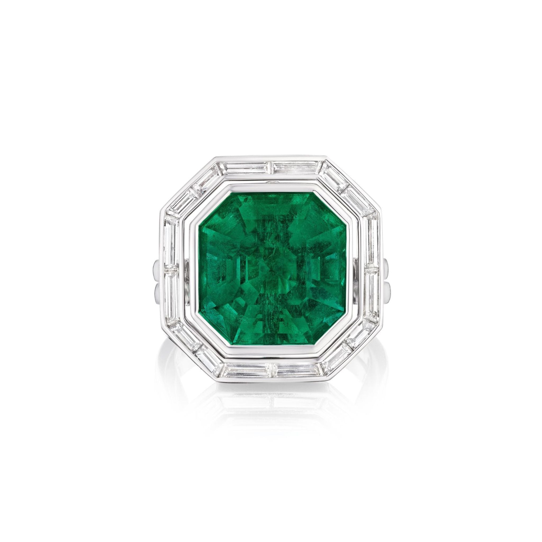 The Bespoke Channel Set Trapezoid Baguette Diamond Ring Jacket in White Gold showcases a striking octagonal green emerald center, bordered by channel-set baguette diamonds on a sleek white gold band.
