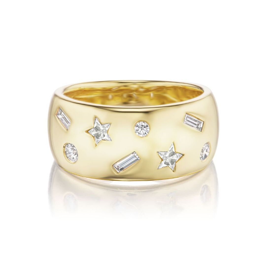 The Celestial Cigar Band in Yellow Gold with Mixed Shape Diamonds features 18k gold and round, baguette, and star-shaped diamonds scattered across a polished band.