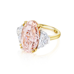 The Oval Pink Diamond Engagement Ring with Epaulette Diamond Side Stones in Platinum and Yellow Gold features a large pink oval center diamond, flanked by two epaulette white diamonds, shown on a white background.