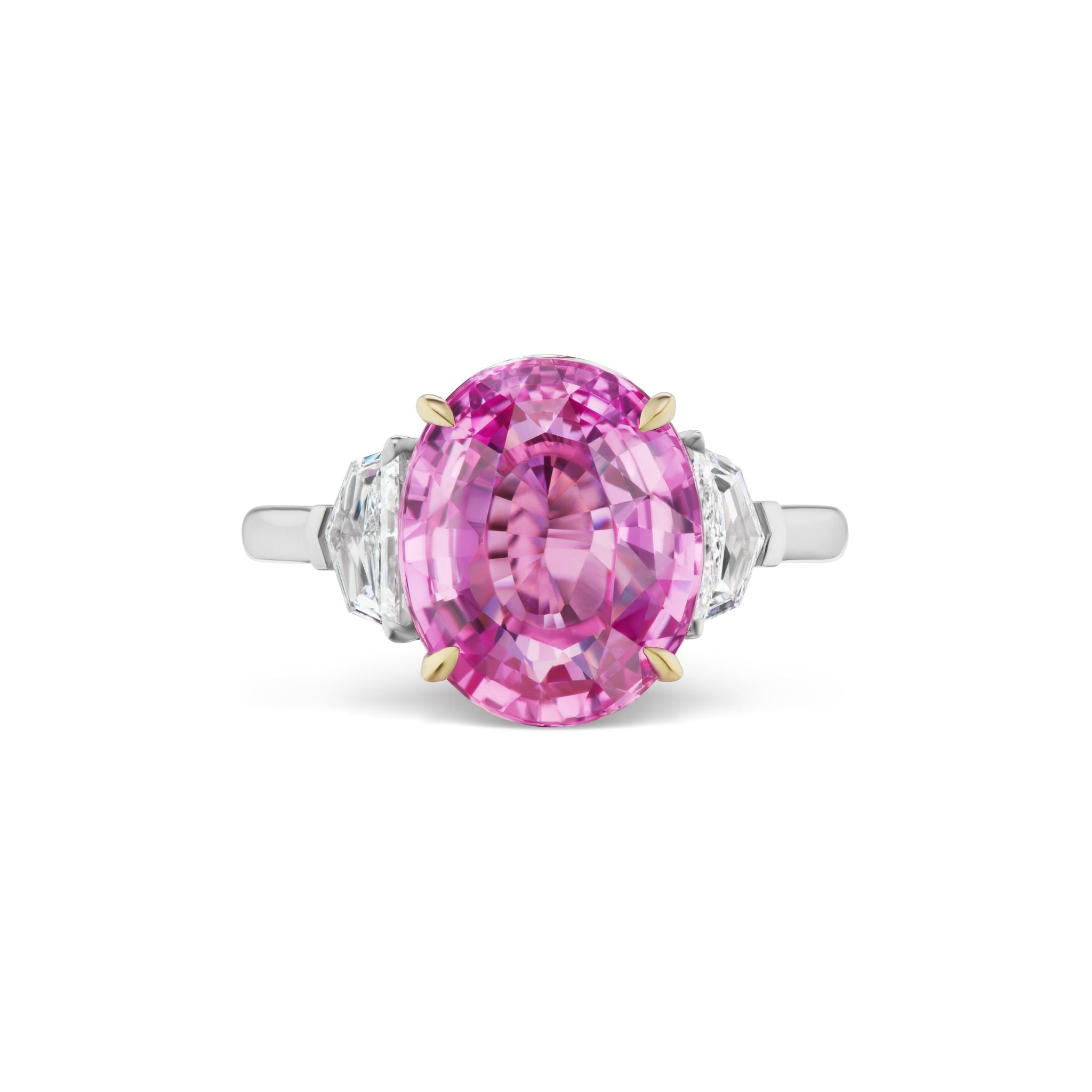 The Oval Sapphire Engagement Ring with Epaulette Diamond Side Stones showcases a breathtaking large oval pink sapphire at its center, set in 18K white gold and accented by two sparkling epaulette-shaped diamond side stones for an elegant touch.