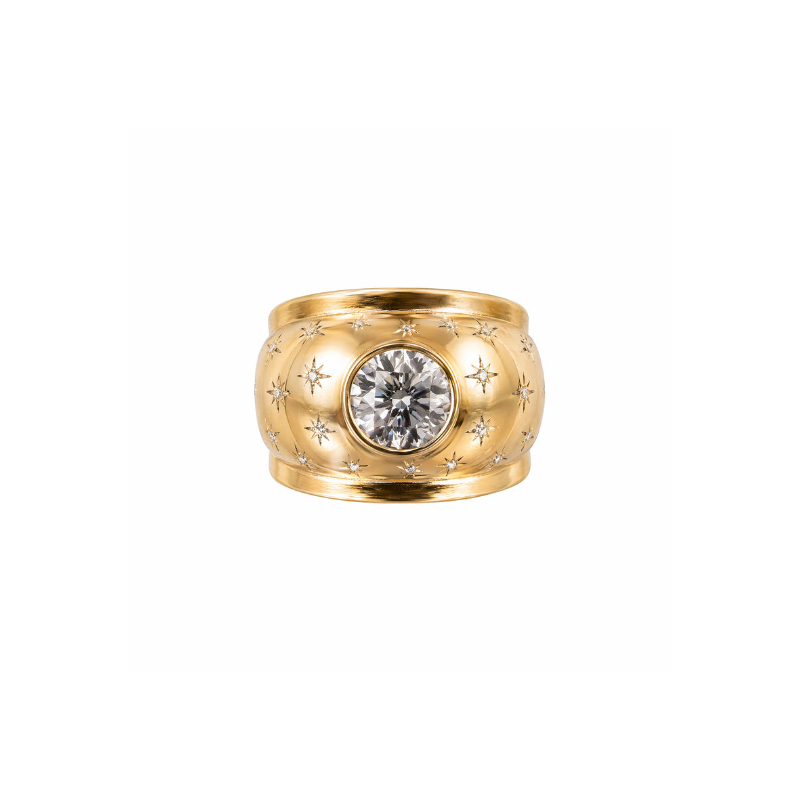 The Rose Gold and Diamond Ring, circa 1945, showcases a wide band with an old European-cut diamond in a starburst pattern, accented by smaller engraved stars on its rose gold surface.