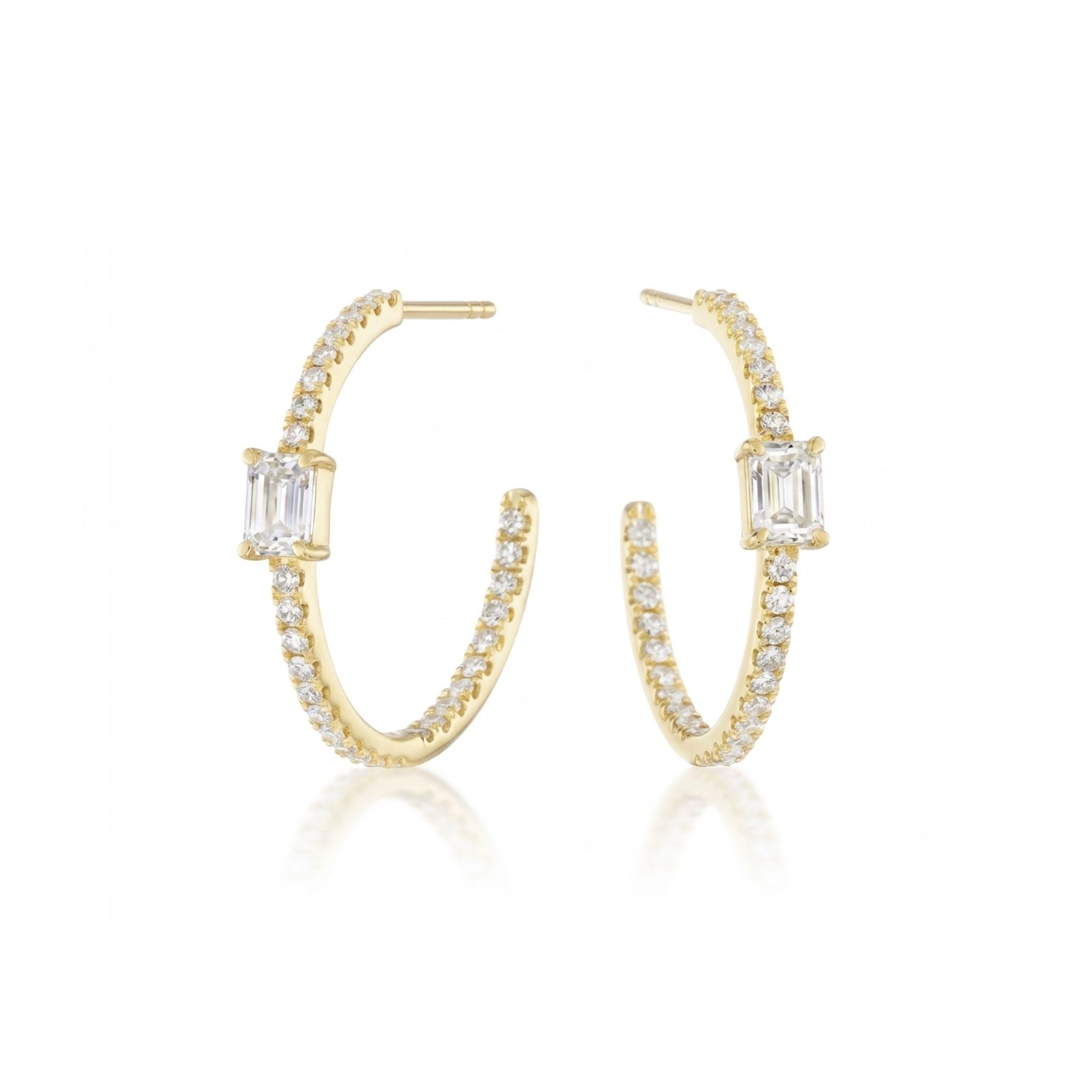 The Pavé Hoop with Emerald Cut Diamonds in Yellow Gold features small round diamonds along each 18k gold hoop and a rectangular emerald cut diamond at the center, shown on a white background.