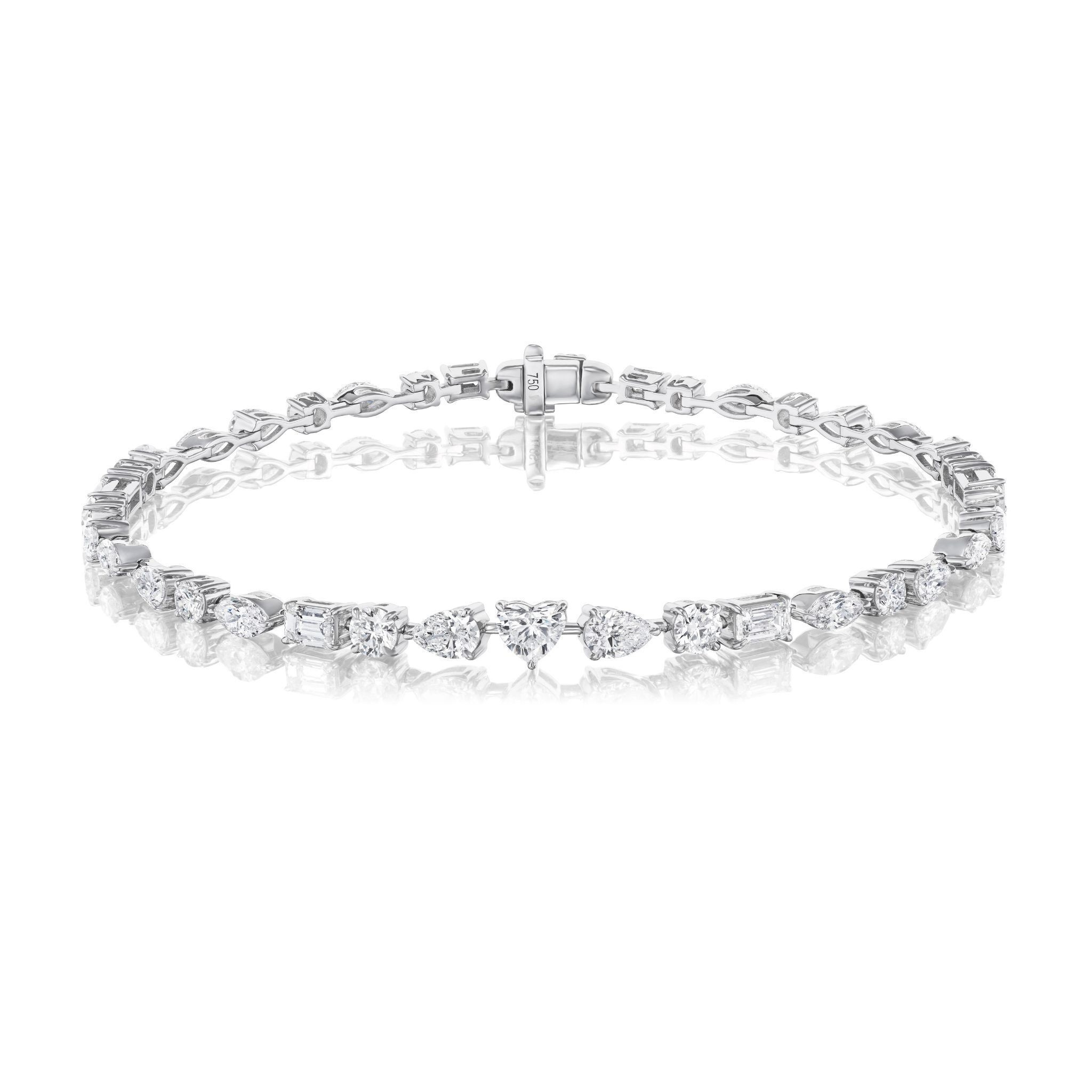 The East-West Mixed Shape Tennis Bracelet is a delicate silver piece showcasing various clear gemstones in a continuous line with a secure clasp, displayed on a white background.