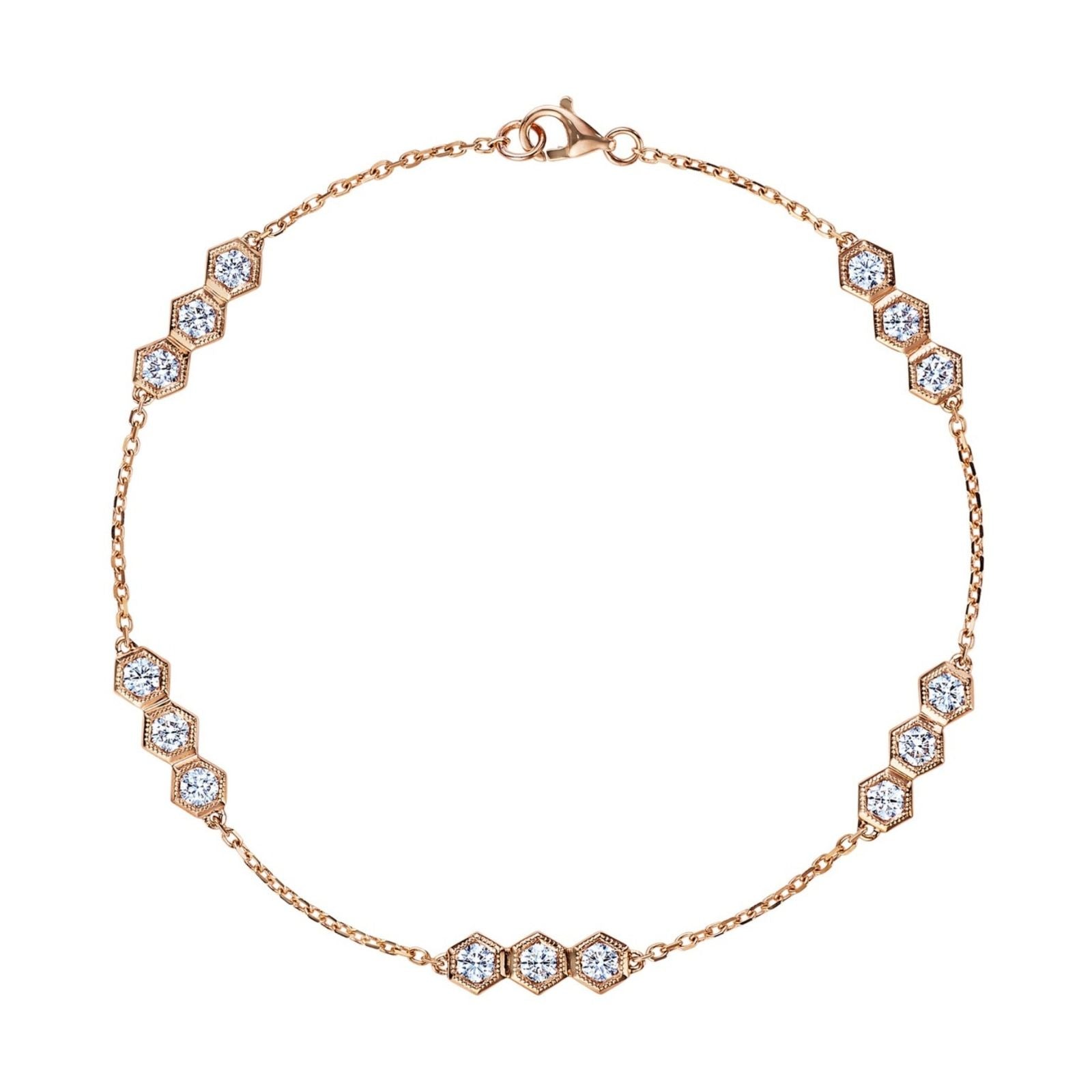 The Serpentine Station Bracelet with Hexagon Diamond Trios features clusters of round brilliant diamonds in 18k gold hexagonal settings, evenly spaced along the chain and secured with a lobster clasp.