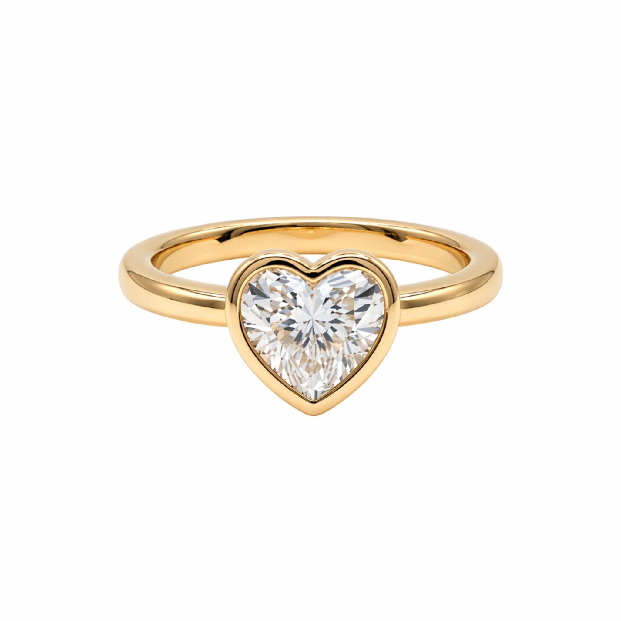 The Bezel Set Heart Shape Diamond Engagement Ring in Yellow Gold features a heart-shaped diamond solitaire in a bezel setting, shown on a white background.
