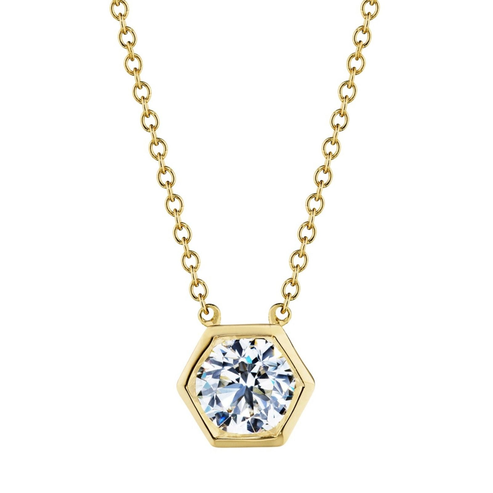 The Hexagon Bezel Set Round Brilliant Diamond Pendant features a gold chain and a hexagon pendant with a large, round, bezel-set diamond at its center—modern elegance inspired by the classic solitaire look.