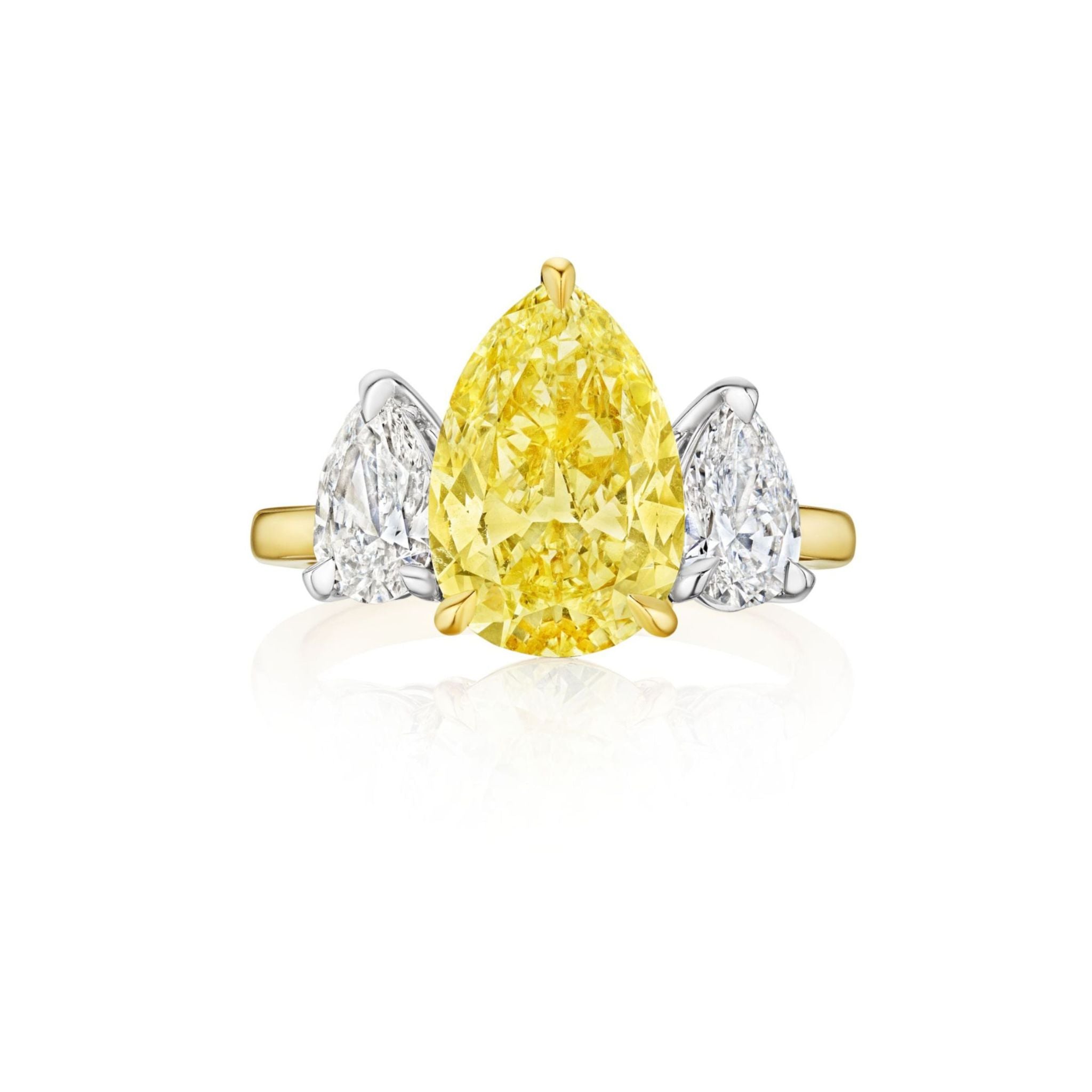 Introducing the Pear Shape Yellow Diamond Ring with White Diamond Side Stones, showcasing a striking pear-shaped yellow diamond at its center, elegantly complemented by two smaller pear-shaped white diamonds on either side.
