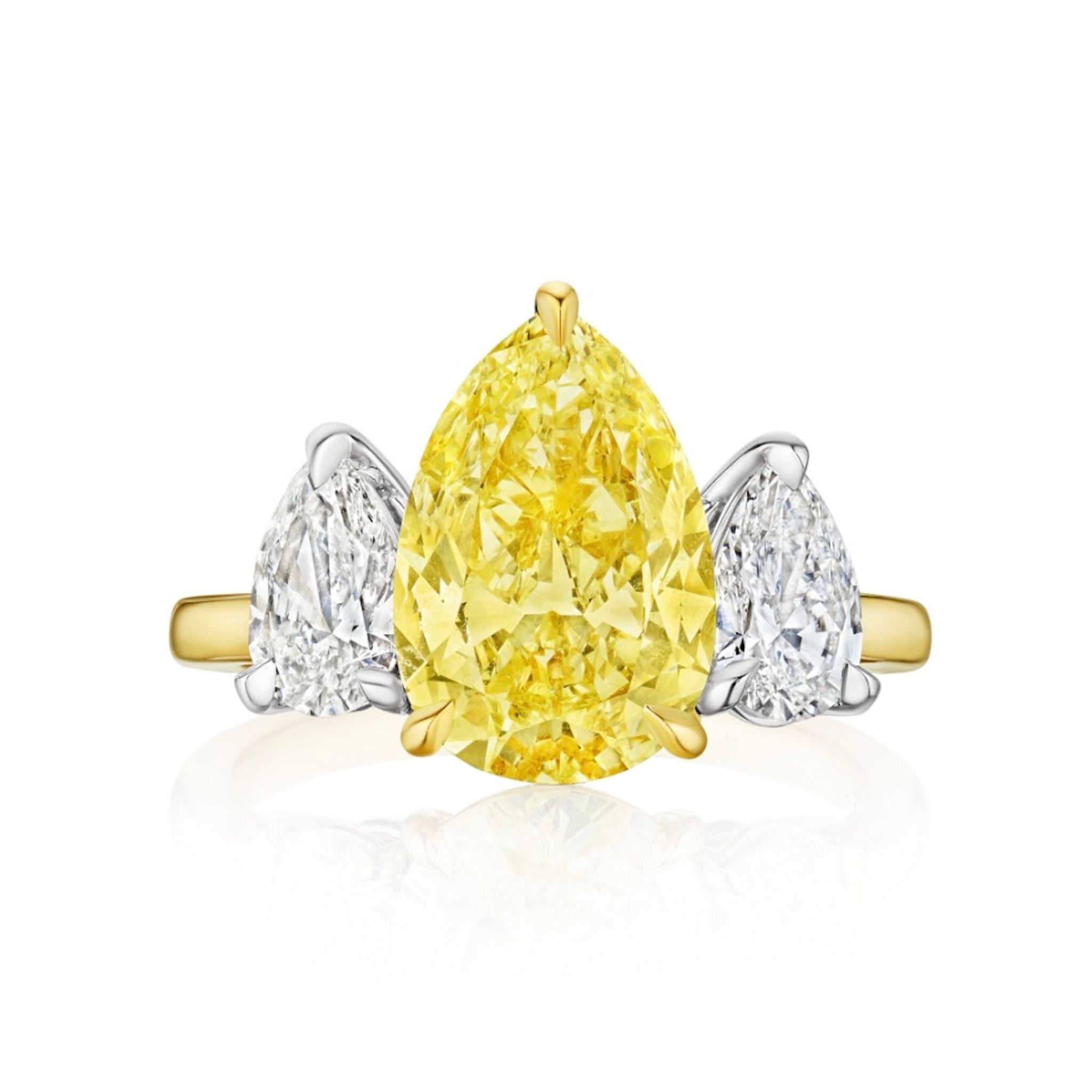 The Pear Shape Yellow Diamond and Diamond Ring in Yellow Gold features a central pear-shaped yellow diamond, accented by two smaller pear-shaped white diamonds on each side, all set on a stylish yellow and white gold band.