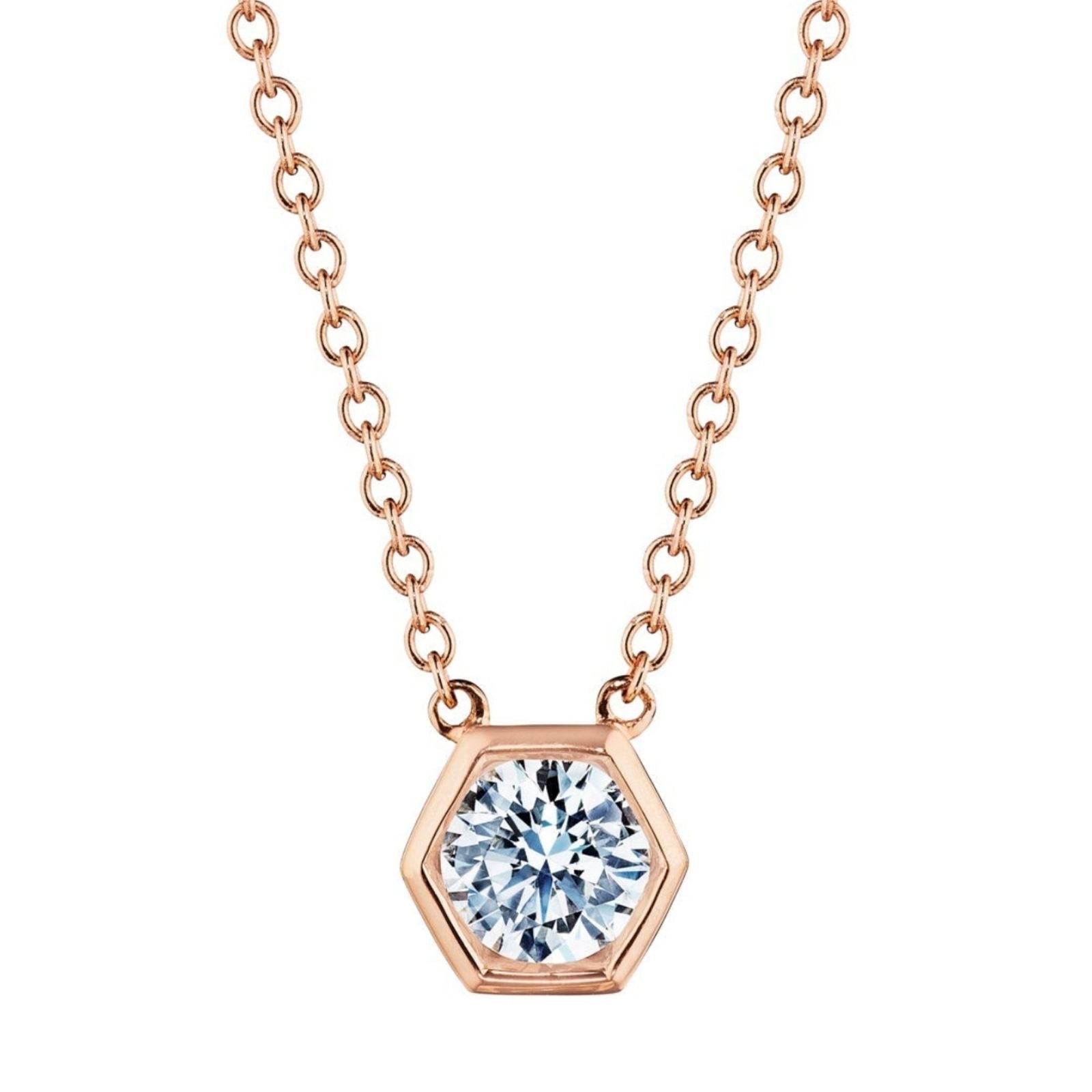 The Hexagon Bezel Set Round Brilliant Diamond Pendant showcases a round, sparkling diamond set in a rose gold hexagon bezel, hanging from a delicate rose gold chain.