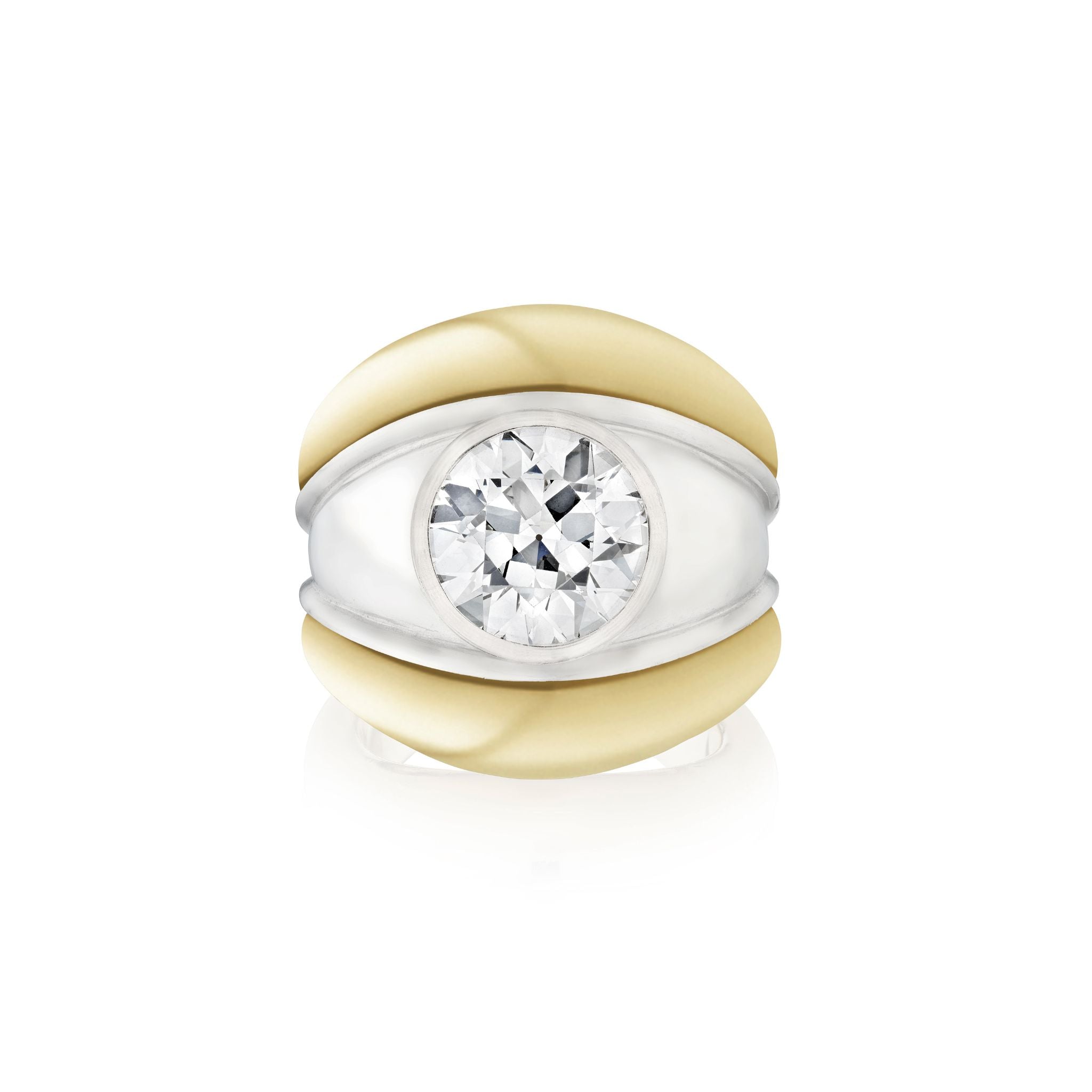 The Round Diamond Engagement Ring features a large center diamond set in a wide yellow gold band with white gold accents. Its modern, bold design includes silver detailing and a smooth, polished finish.