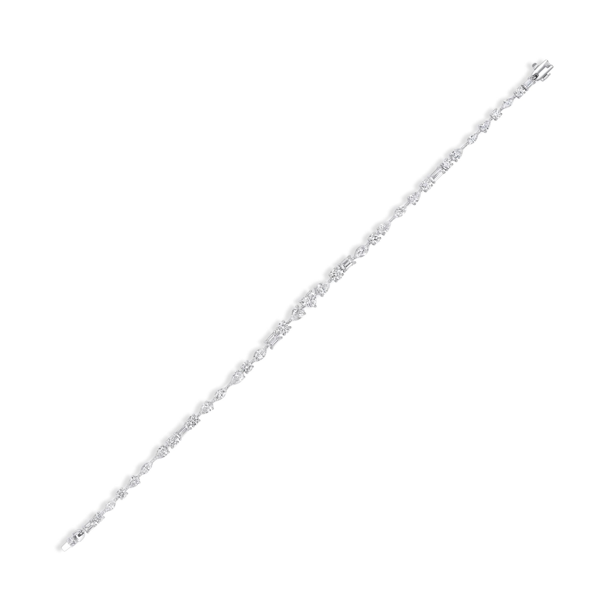 The East-West Mixed Shape Tennis Bracelet is a slim, elegant silver piece featuring small, sparkling gemstones arranged evenly along its length, shown against a plain white background.