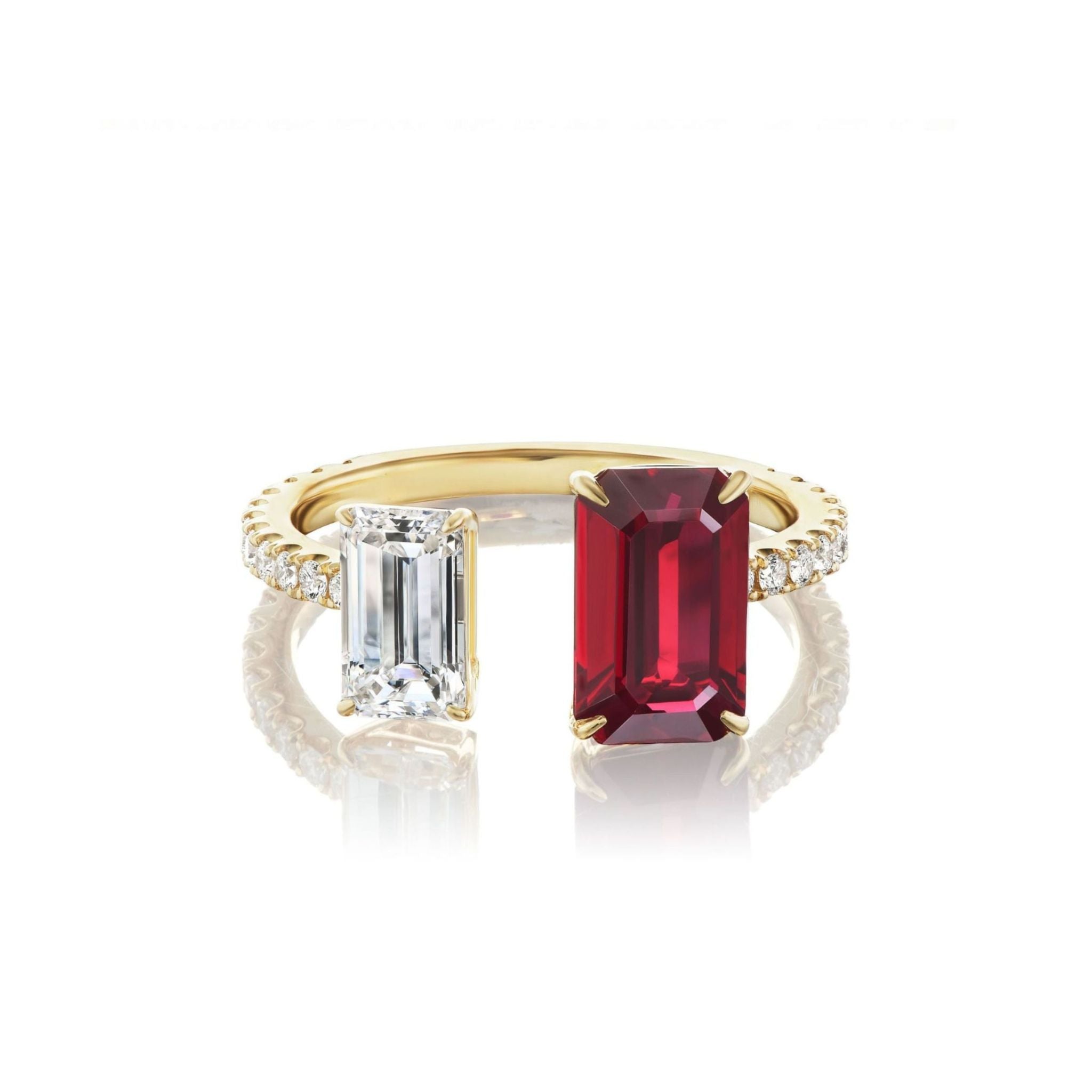 The Toi et Moi Pavé Ring features an emerald cut ruby and diamond set side by side in luxurious 18k yellow gold, with a band adorned with a row of small diamonds.