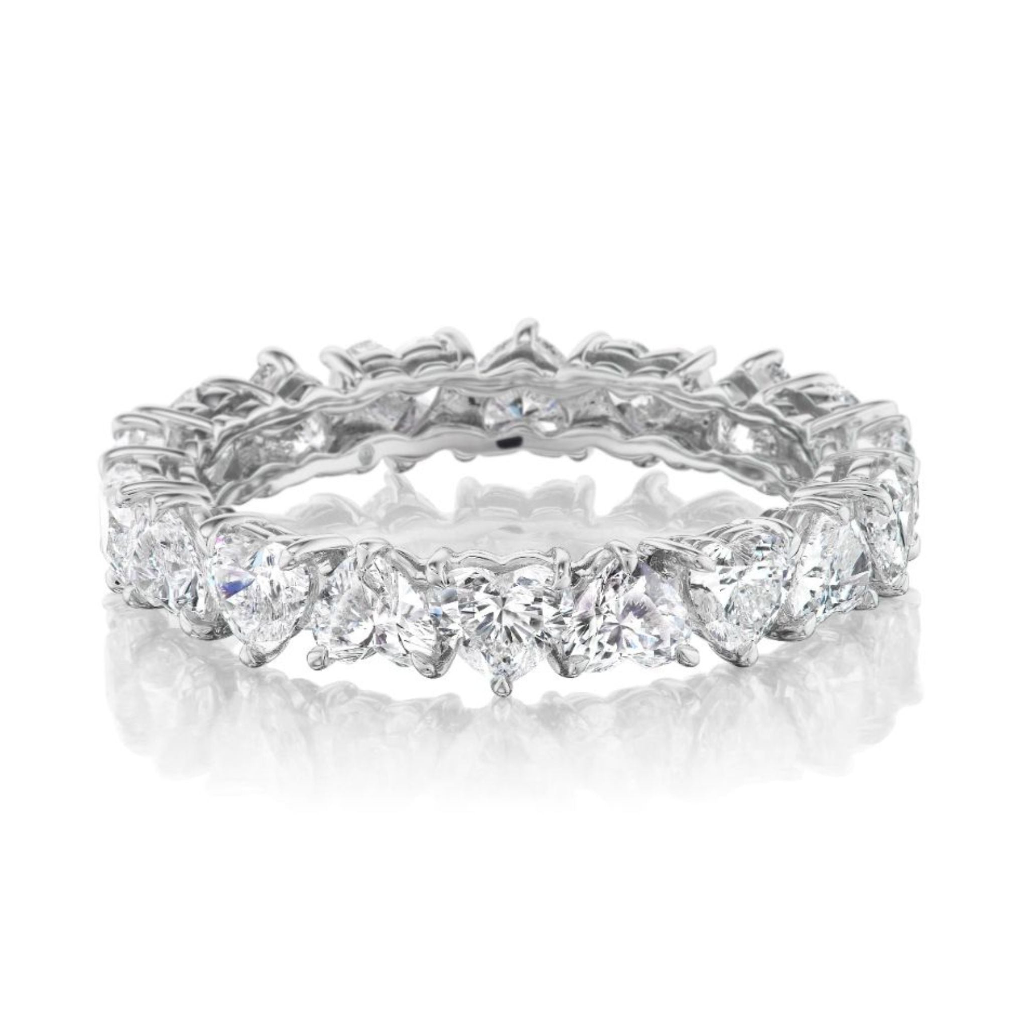 The Up and Down Heart Diamond Eternity Band features sparkling heart-shaped diamonds encircling the silver band, ideal as a bridal ring, showcased on a white reflective surface.