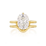 A Double Band North-South Prong Set Cushion Cut Diamond Engagement Ring, expertly crafted in lustrous 18k yellow gold and featuring a striking cushion cut diamond at the center.