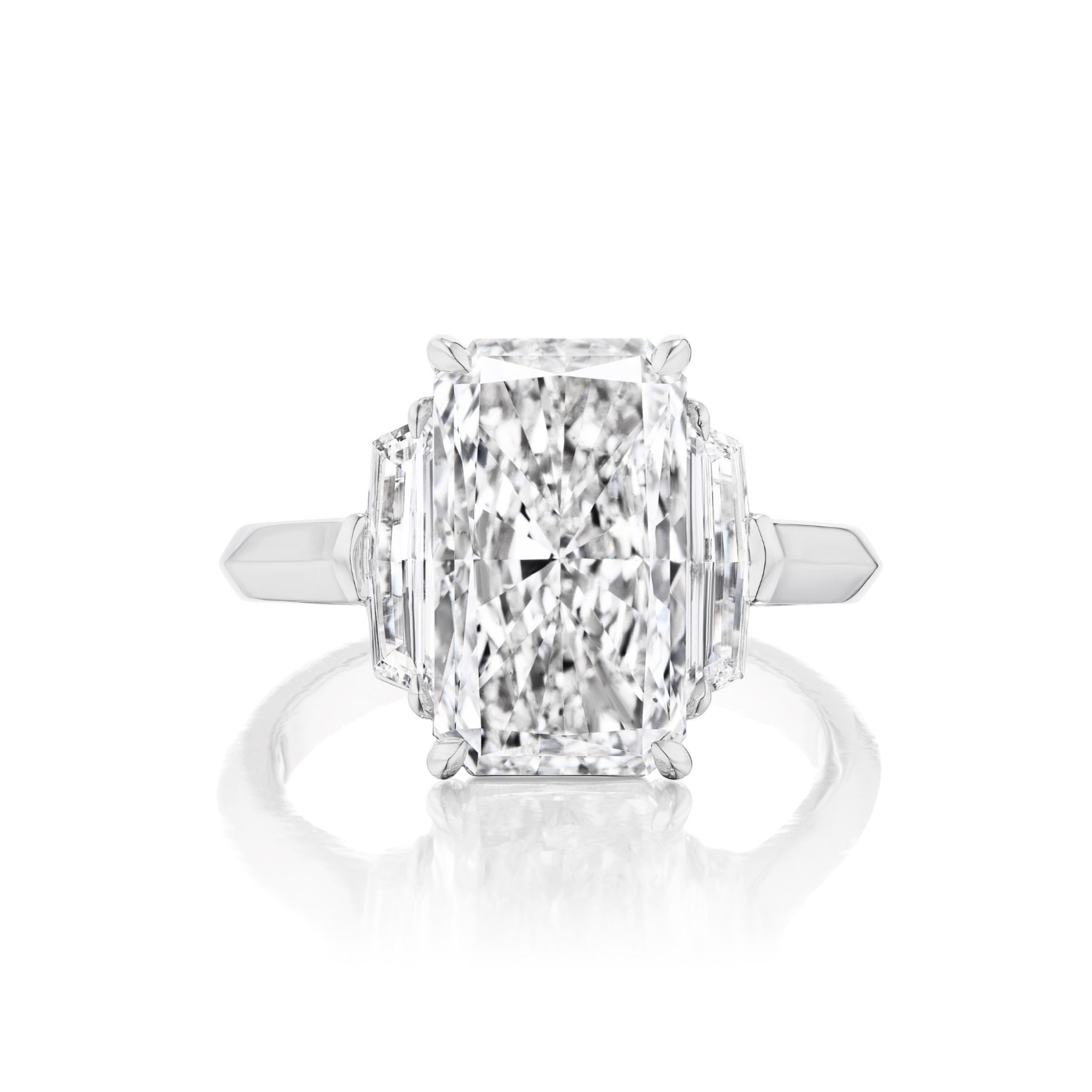 An elegant engagement ring in white gold or platinum, the Elongated Radiant Cut Diamond Engagement Ring with Epaulette Side Stones showcases a large, rectangular radiant-cut diamond flanked by distinctive epaulette-shaped side stones, all set against a luminous white backdrop.