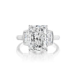 A rectangular Radiant Cut Diamond Engagement Ring with bezel-set epaulette side stones on a white metal band, shown against a white background.