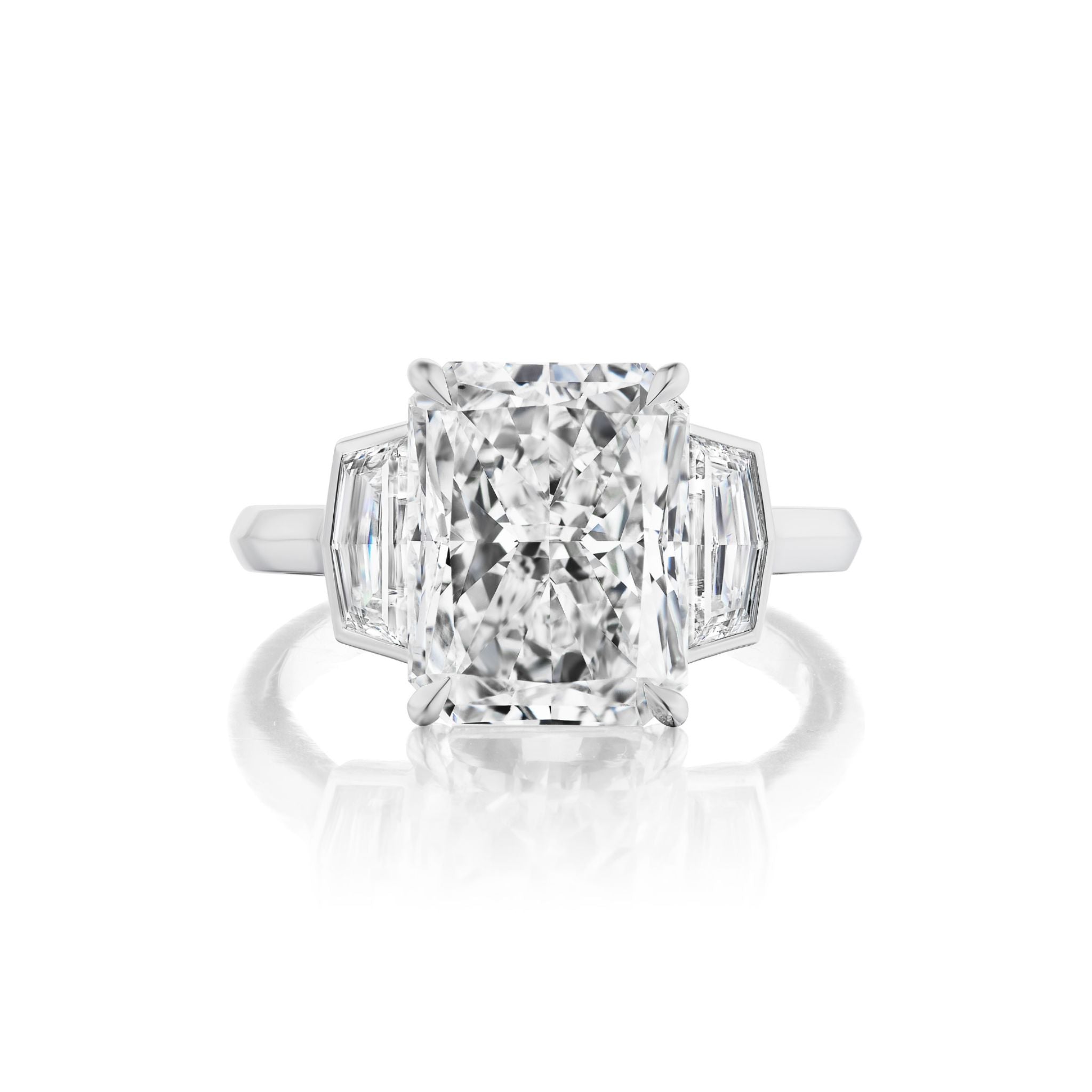 A rectangular Radiant Cut Diamond Engagement Ring with bezel-set epaulette side stones on a white metal band, shown against a white background.