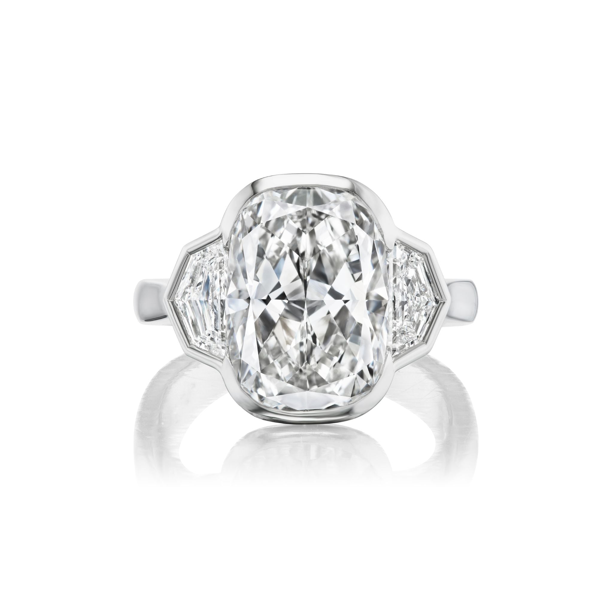 A radiant cut diamond engagement ring with a bezel setting and epaulette side stones, set in a sleek platinum band and displayed against a white background.