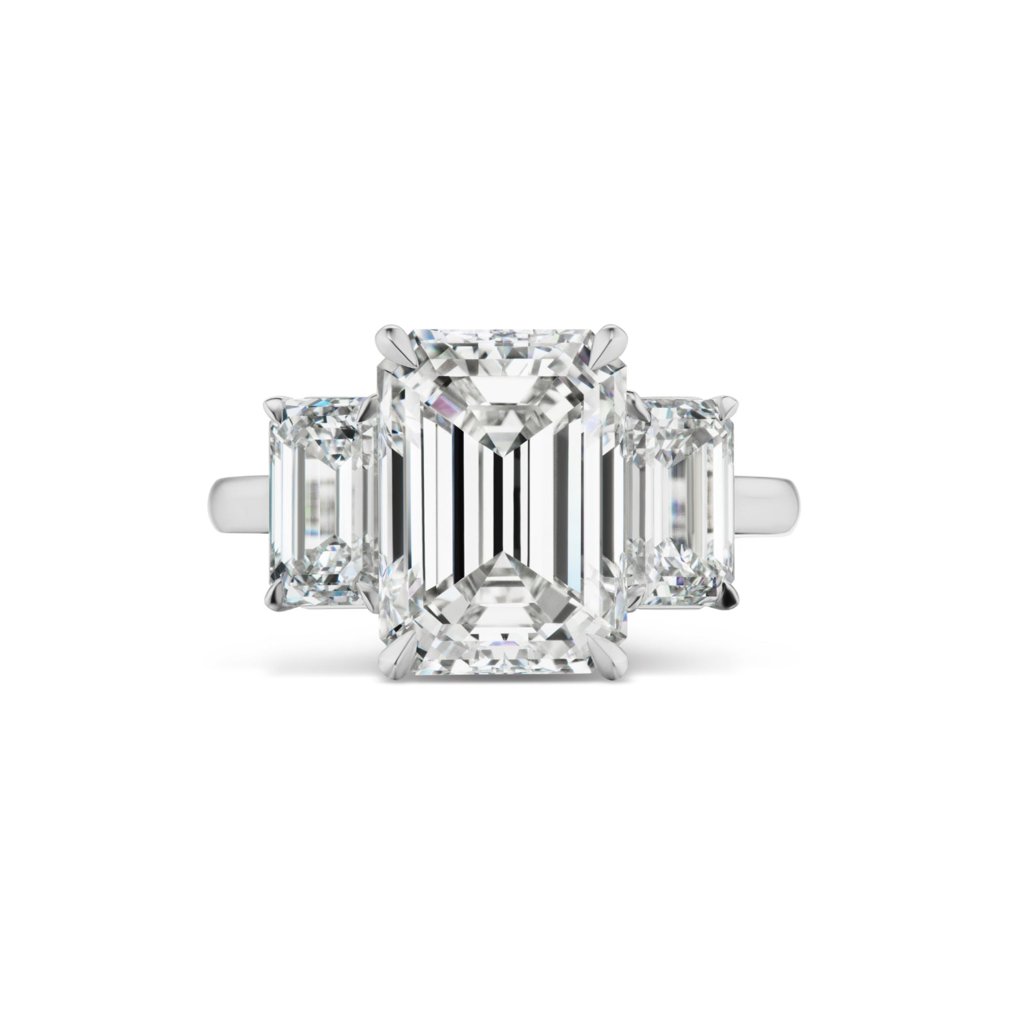 The Emerald Cut Diamond Engagement Ring with Emerald Cut Side Stones features a stunning emerald-cut diamond center stone set in white gold or platinum, accented by two smaller emerald-cut diamonds on each side, making it an exquisite choice for a bridal ring.