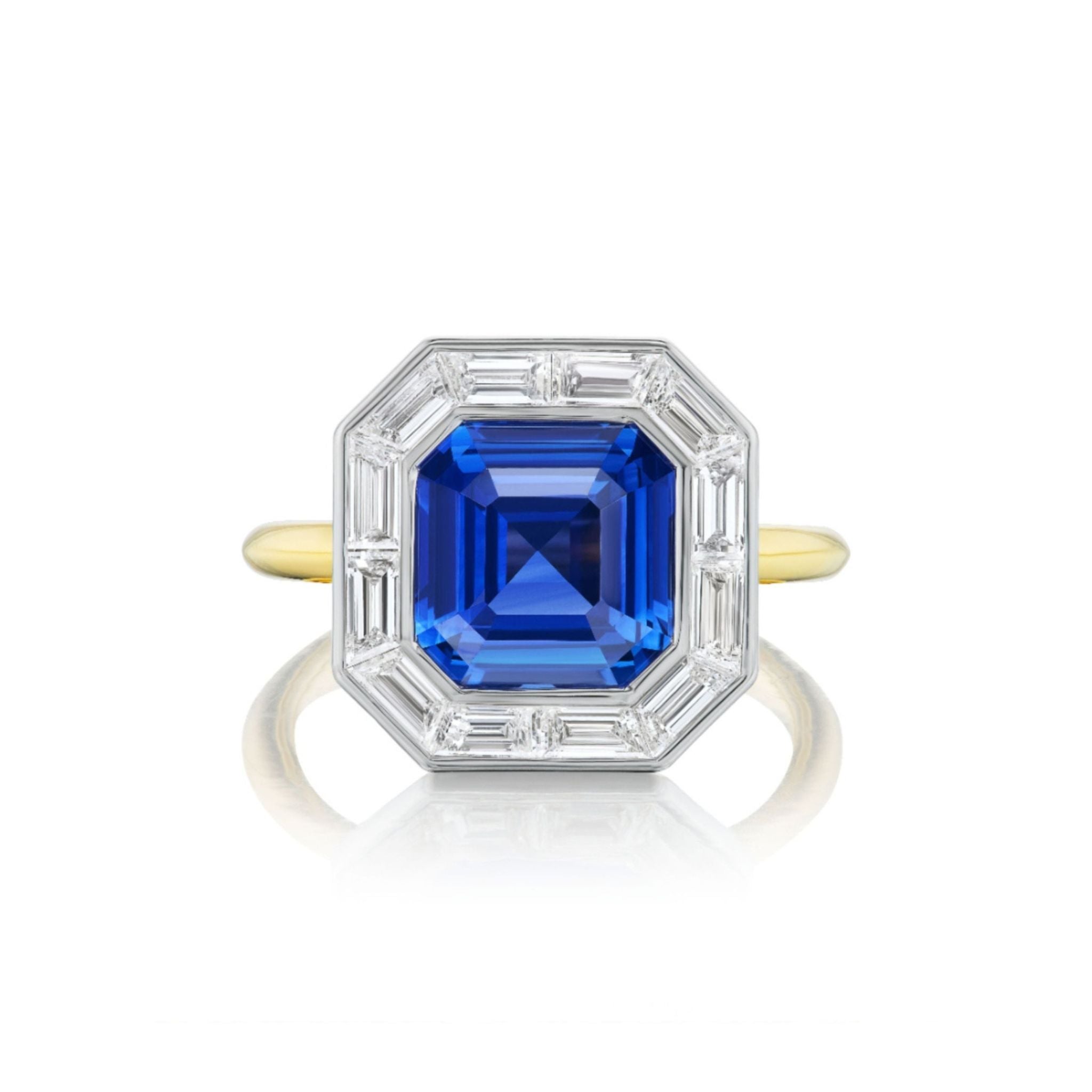 Mosaic Ring with Asscher Cut Sapphire and Baguette Diamonds: an 18k gold ring featuring a prominent Asscher cut blue sapphire at the center, encircled by a border of rectangular baguette diamonds set in white metal, displayed from above on a white background.
