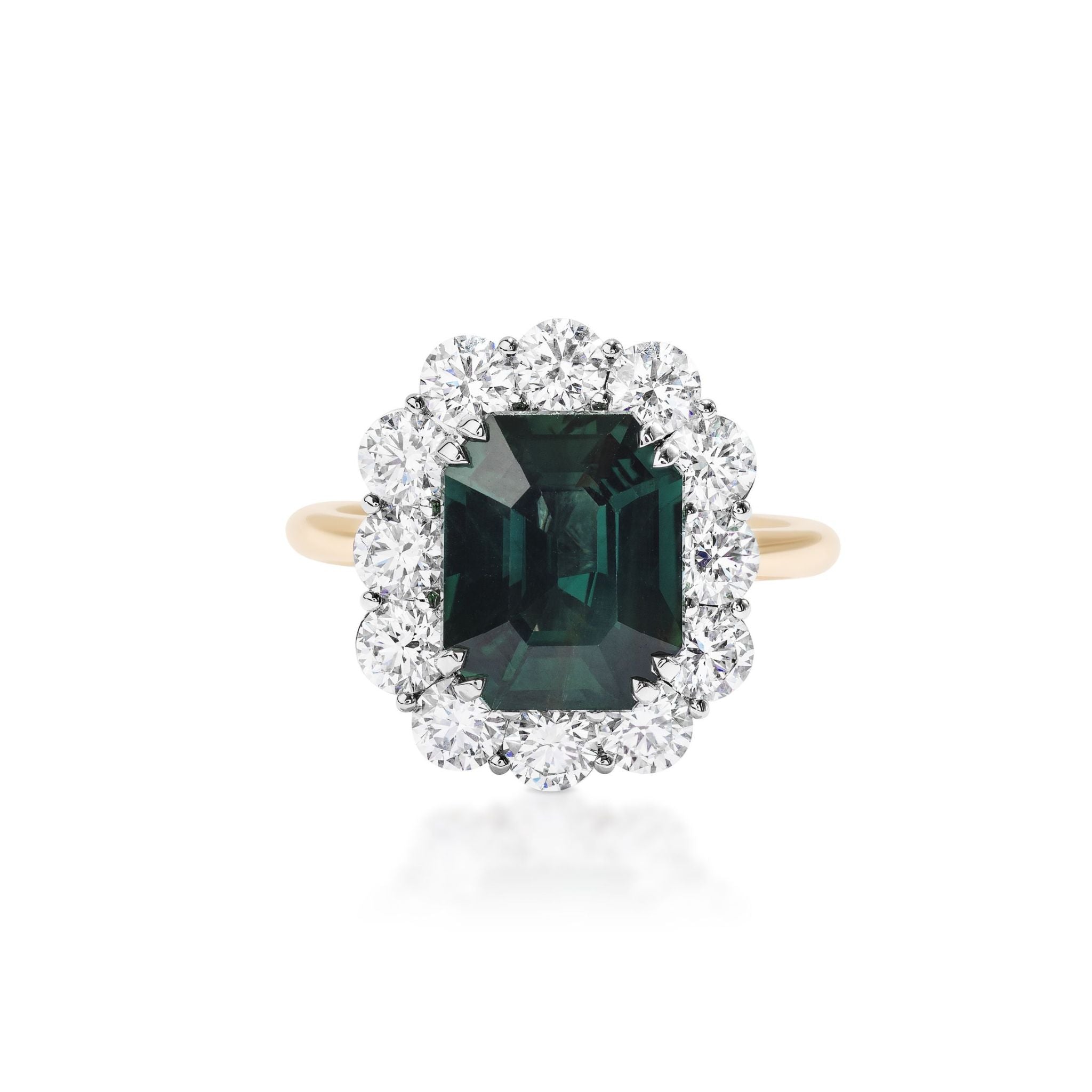 The Elongated Asscher Cut Sapphire Ring with Round Diamond Halo features a striking green sapphire in an Asscher cut at its center, set in 18k gold and encircled by a halo of round white diamonds, shown against a white background.