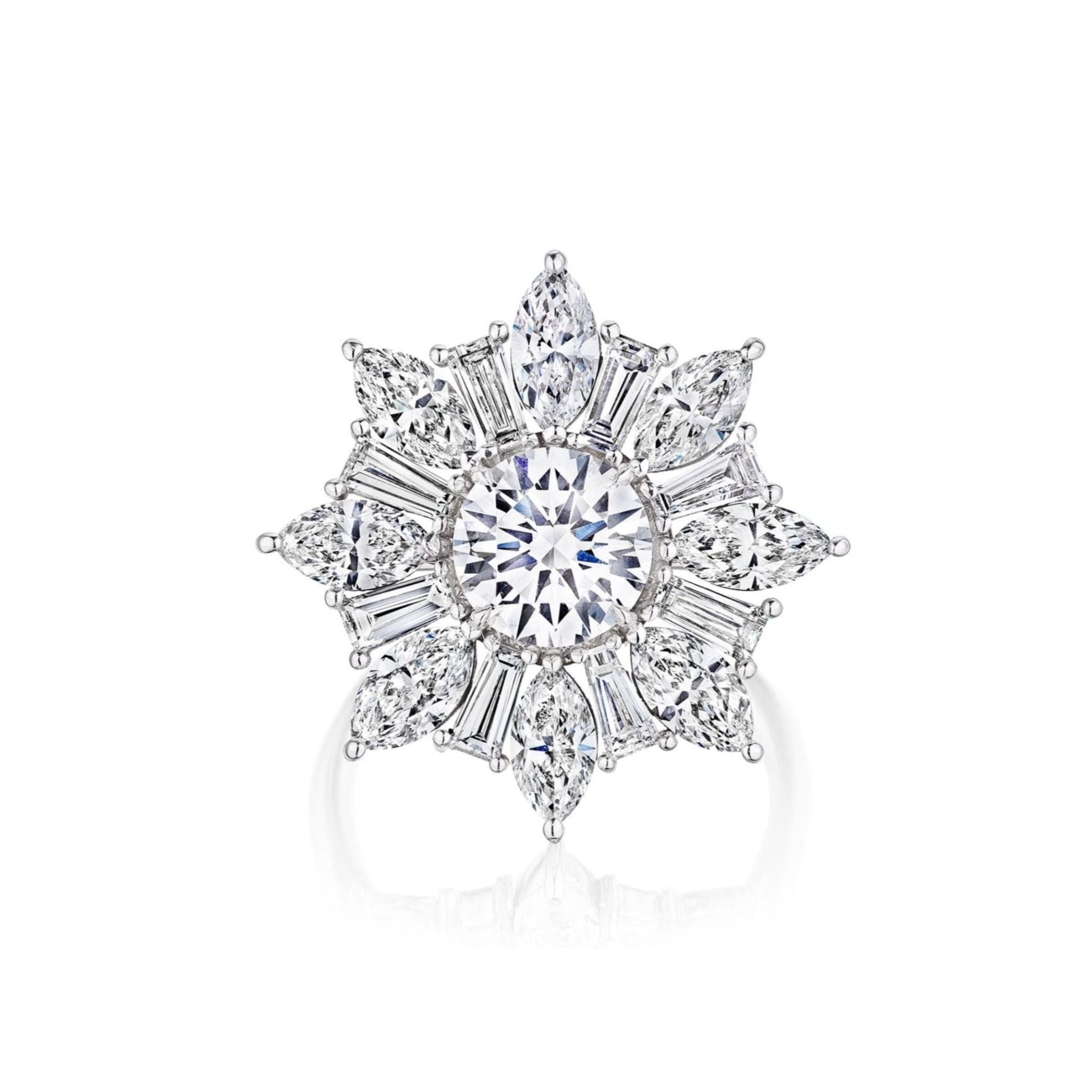 Introducing the Snowflake Ring in White Gold with Mixed Shape Diamonds—an exquisite 18k white gold ring showcasing a dazzling round center diamond, surrounded by a captivating snowflake design crafted from marquise, pear, and baguette-cut diamonds.