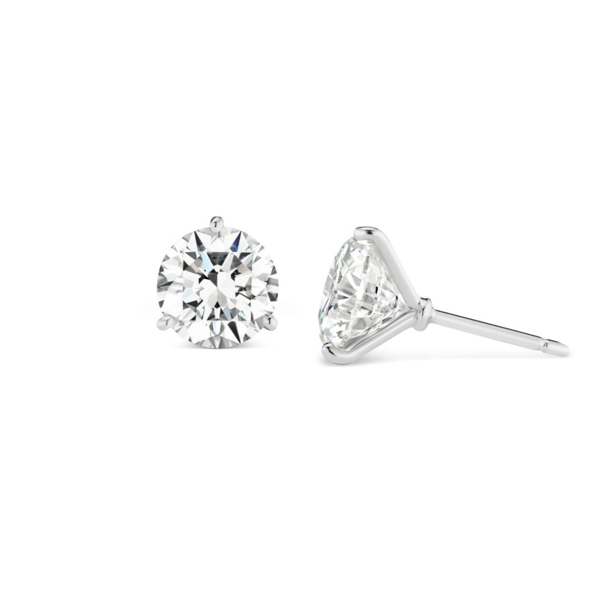 A pair of Classic Round Diamond Studs in a martini setting, featuring GIA Certified round brilliant diamonds set in 18k white gold, displayed from the front and side against a white background.