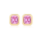 The Asscher Cut Pink Sapphire Studs in Yellow Gold feature Asscher cut pink sapphires set in a four-prong 18k yellow gold setting, shown on a white background.