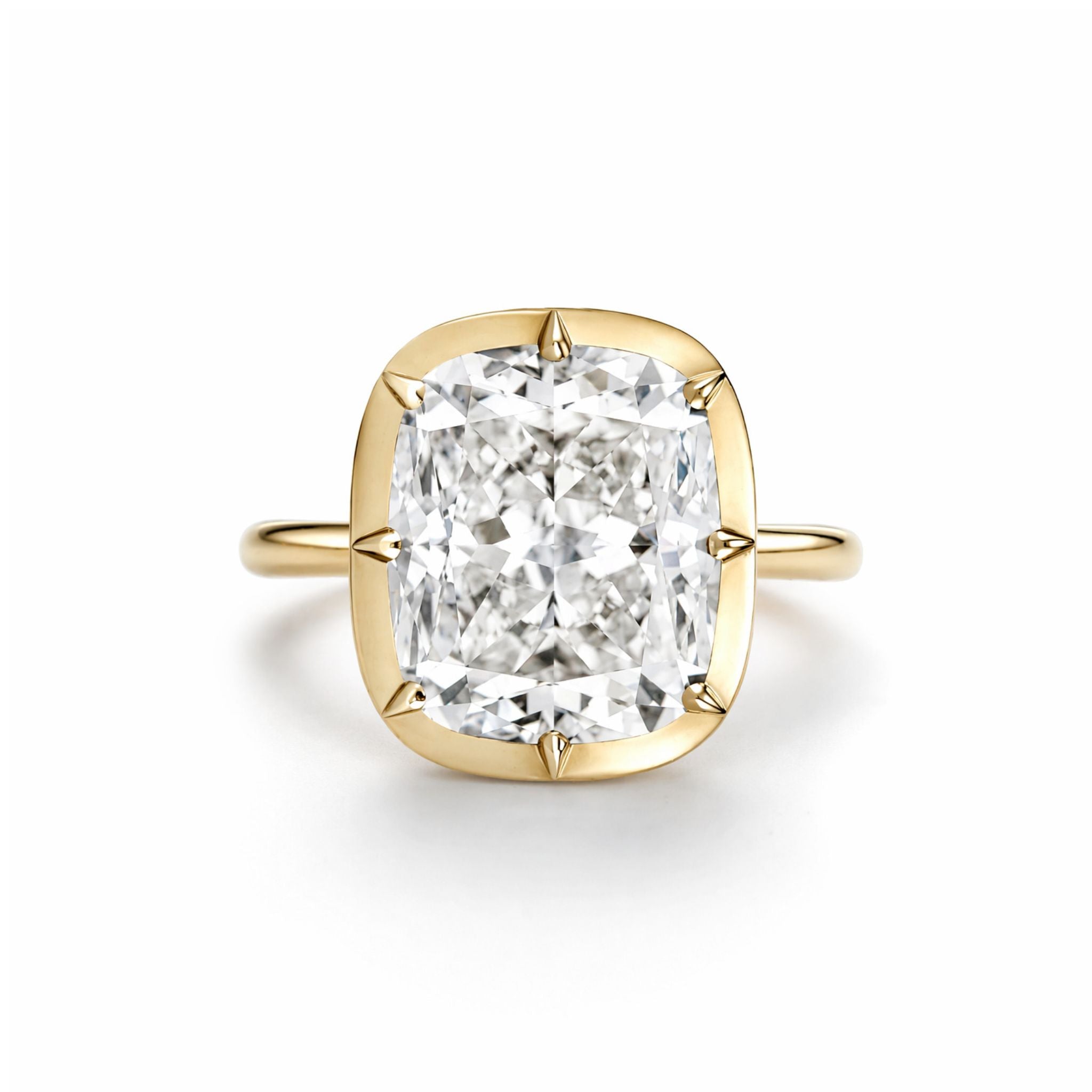 The Collet Set Cushion Cut Diamond Engagement Ring in 18k Yellow Gold showcases a stunning cushion-cut diamond in a timeless four-prong setting, beautifully photographed against a plain white background.