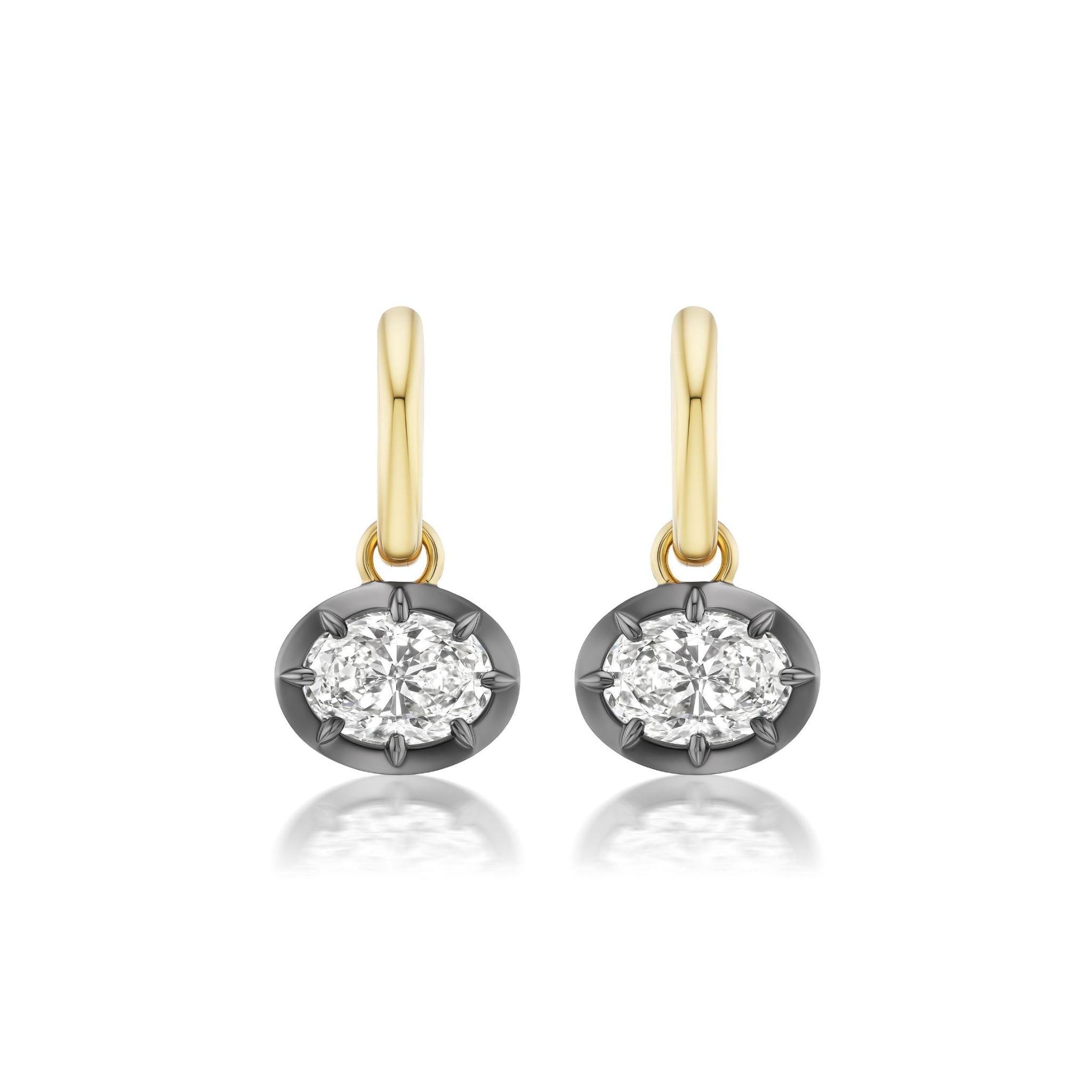 A pair of Collet Set East-West Oval Shape Diamond Drop Earrings in black rhodium and 18k yellow gold, each featuring a sparkling diamond, displayed on a white background.