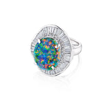 The 1980s Opal and Diamond Ring showcases a mesmerizing oval opal gemstone that shimmers with vibrant blue, green, and orange hues, beautifully surrounded by a halo of baguette and round-cut diamonds, all set in elegant platinum.
