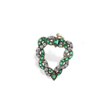 Antique Emerald and Diamond Pendant showcasing cushion-shaped emeralds and old-cut diamonds set in a twisted gold design, circa 1890.