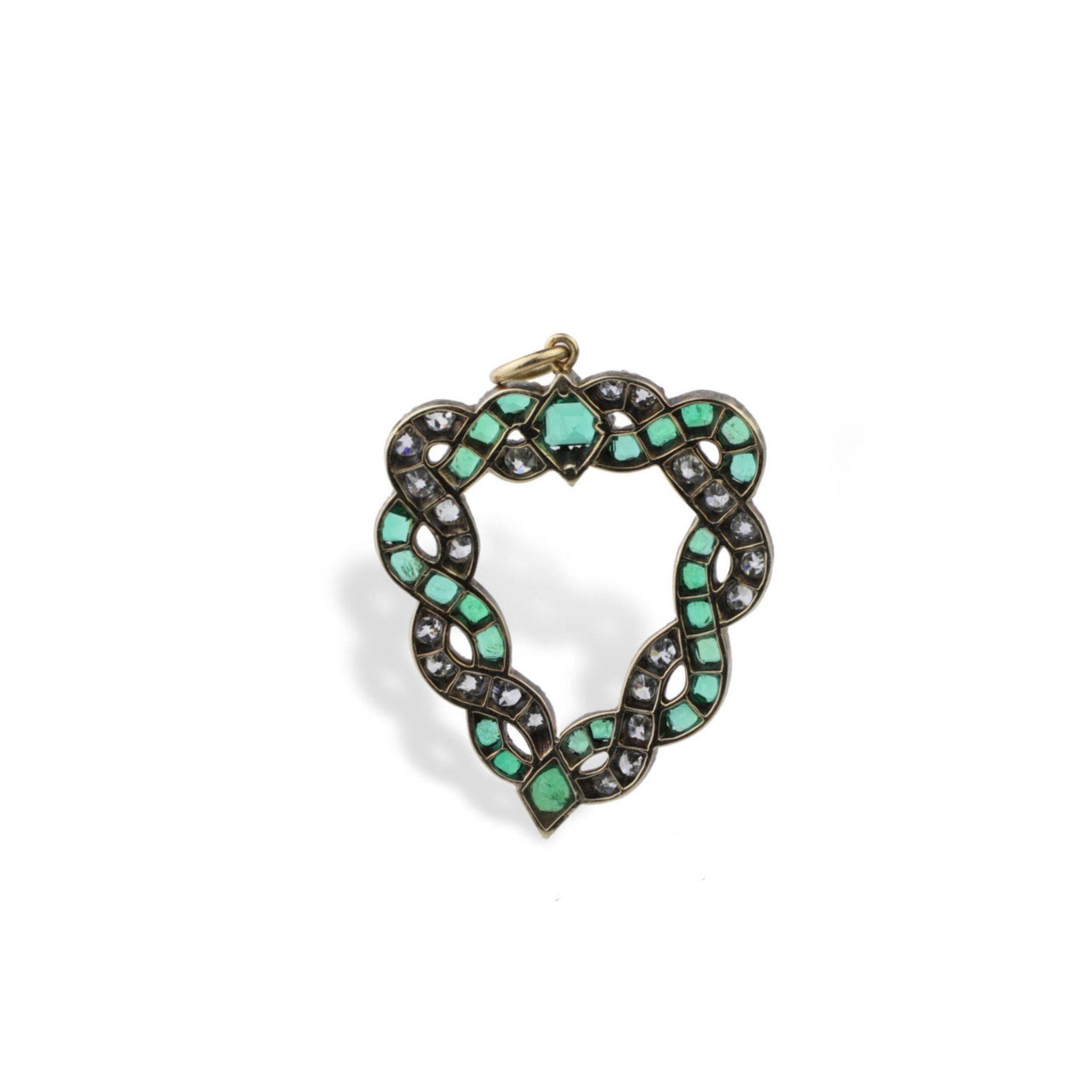Introducing the Antique Emerald and Diamond Pendant: a stunning antique heart-shaped pendant featuring a coiled snake motif adorned with cushion-shaped emeralds and sparkling white gemstones set in gold. The snake’s head, positioned at the top center, is embellished with old-cut diamonds, while its tail gracefully curves down to the bottom point of the heart.