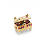 The Vintage Gold and Gem-Set Charm features a petite 14K gold treasure chest with its lid open, adorned with colorful gems like rubies and sapphires, accented by lustrous pearls and revealing an array of jewels within. The chest is elegantly supported by four pearl-like feet.