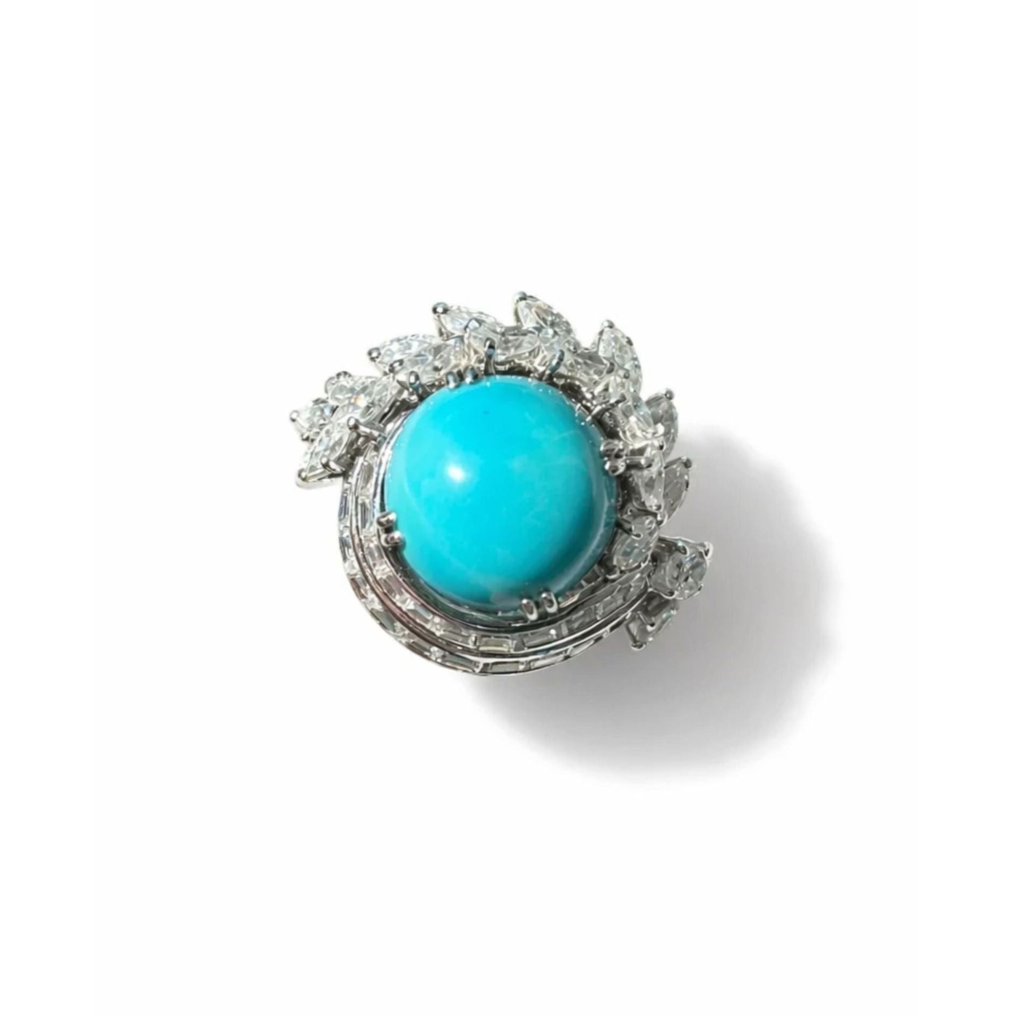 The Turquoise and Diamond Ring showcases a large round turquoise cabochon at its center, encircled by a halo of marquise-cut white gemstones, capturing the timeless elegance of vintage 1970s jewelry, beautifully displayed on a white background.