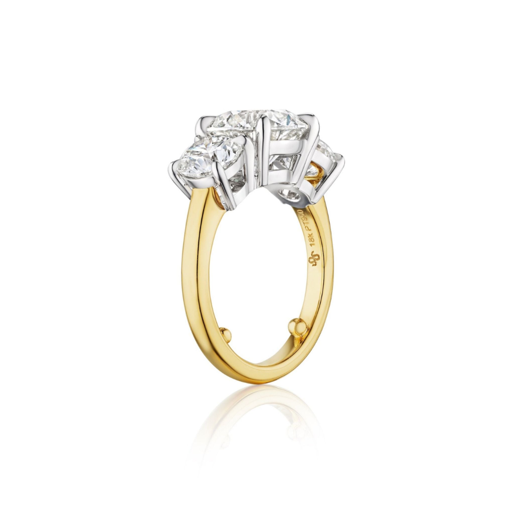 A Diamond Engagement Ring with Round Side Stones in Platinum and Yellow Gold—featuring a raised platinum setting atop a yellow gold band, set with five prominent round diamonds including a stunning center stone—shown from the side on a white background.