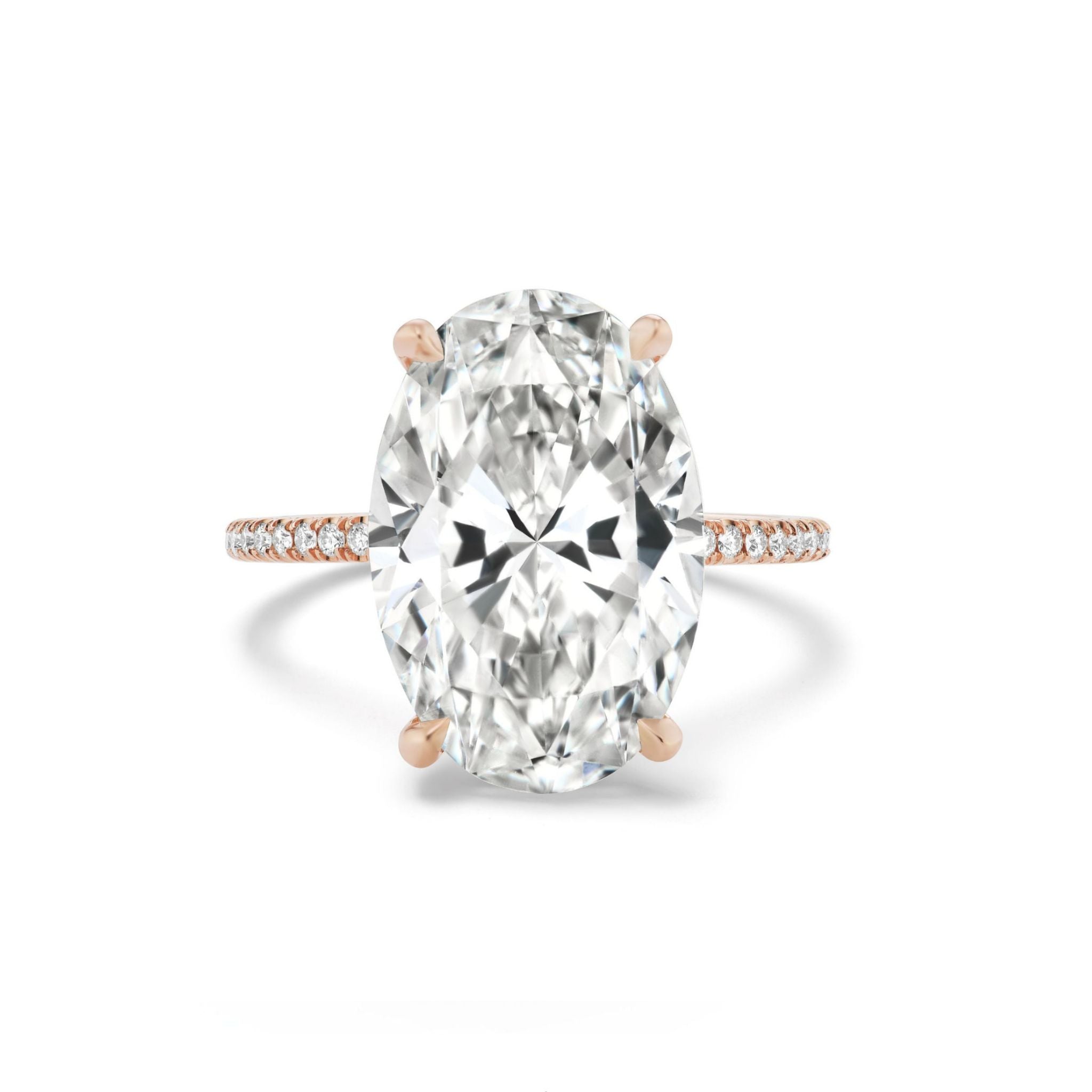 The Oval Diamond Engagement Ring Pavé Band features a large oval diamond set on an 18K rose gold band, elegantly adorned with pavé-set diamonds along the shank and beautifully photographed against a white background.