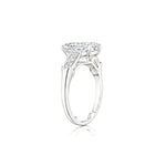 Oval Shape Diamond Engagement Ring with Bullet Side Stones, featuring a striking oval center diamond flanked by two tapered bullet-shaped side stones set on a slim, elegant platinum band, displayed from a side angle on a white background.