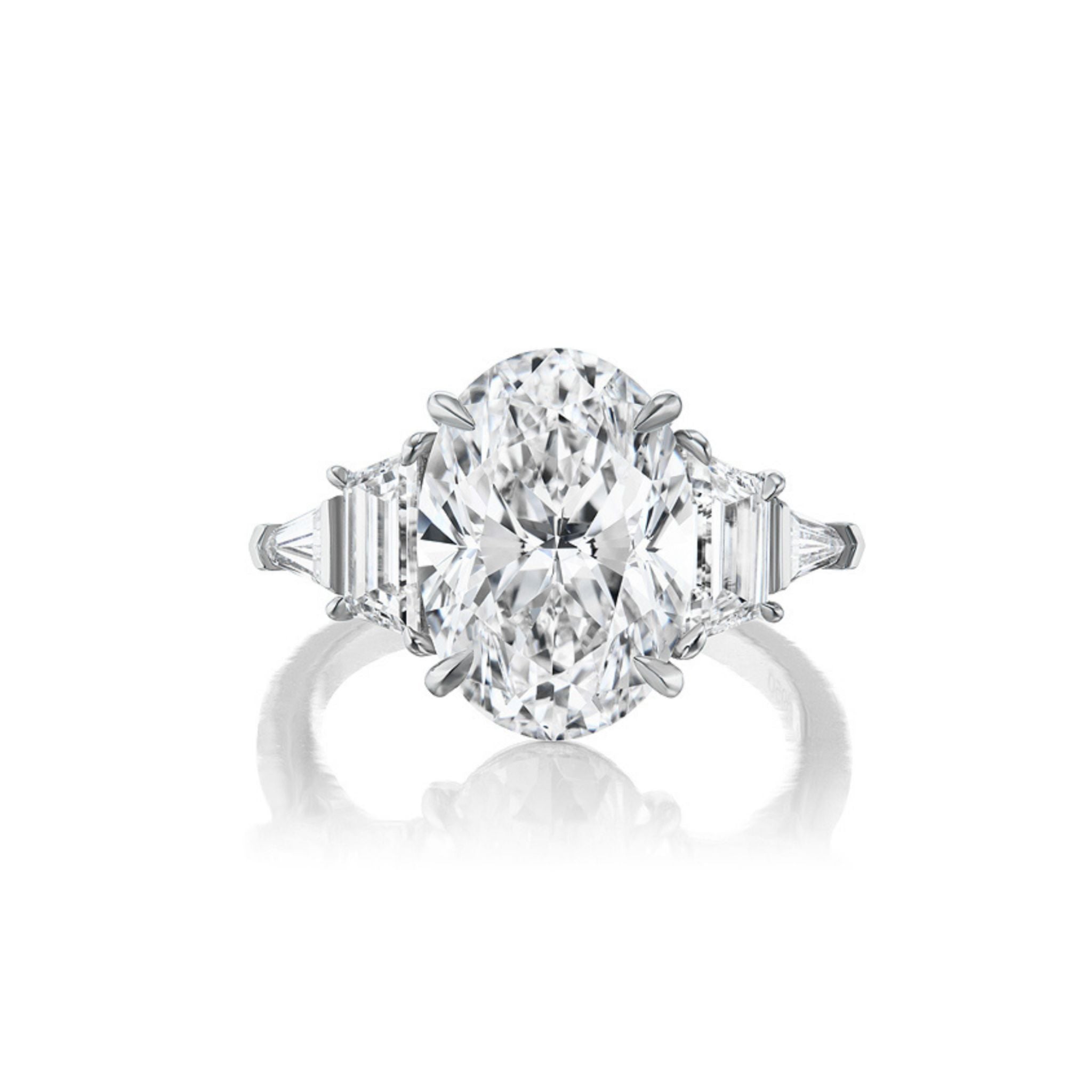 Introducing the Oval Diamond Engagement Ring with Trapezoid and Tapered Baguette Side Stones, showcased against a white background—a breathtaking bespoke design that’s perfect for celebrating life’s most cherished moments.