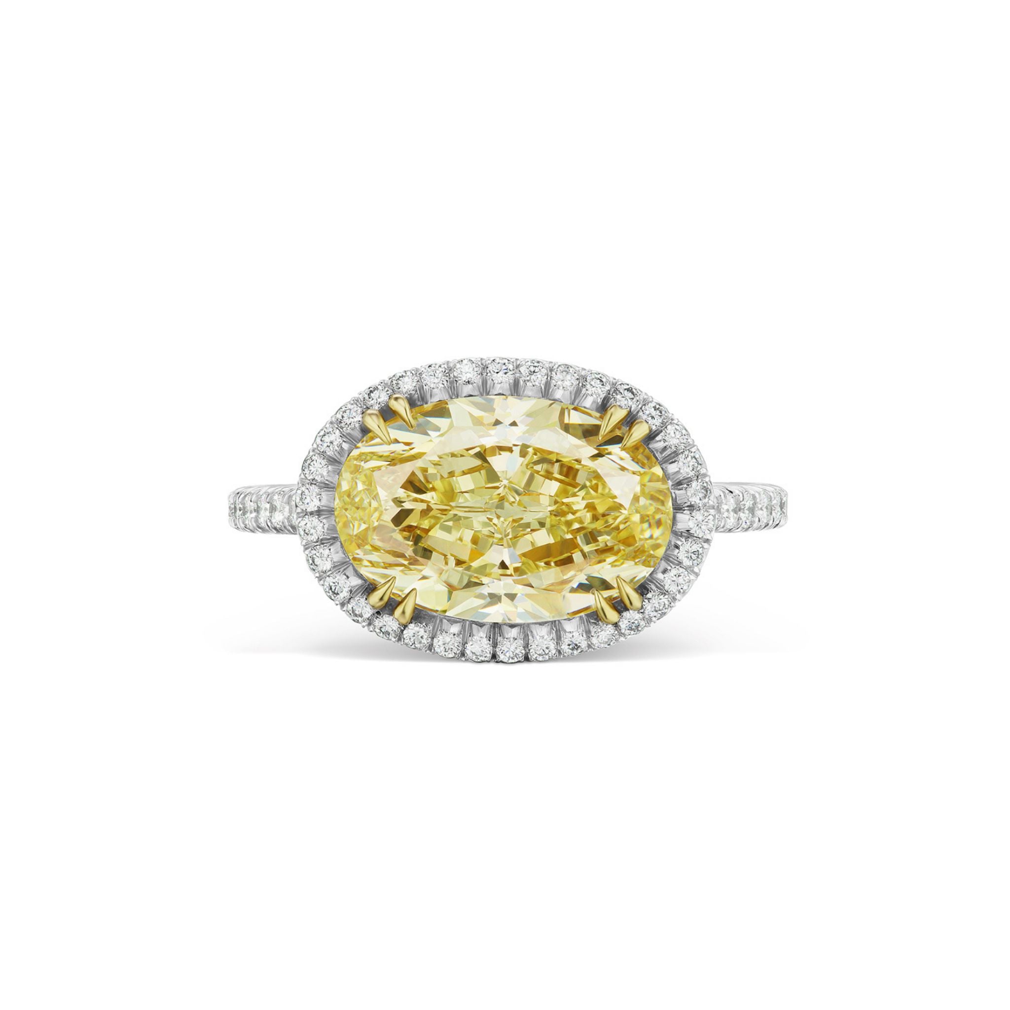 Experience timeless elegance with the East-West Fancy Yellow Oval Diamond Engagement Ring, featuring a striking yellow oval center diamond set in a pavé bezel and band of white and yellow gold—an exquisite choice among bridal rings for your celebration.