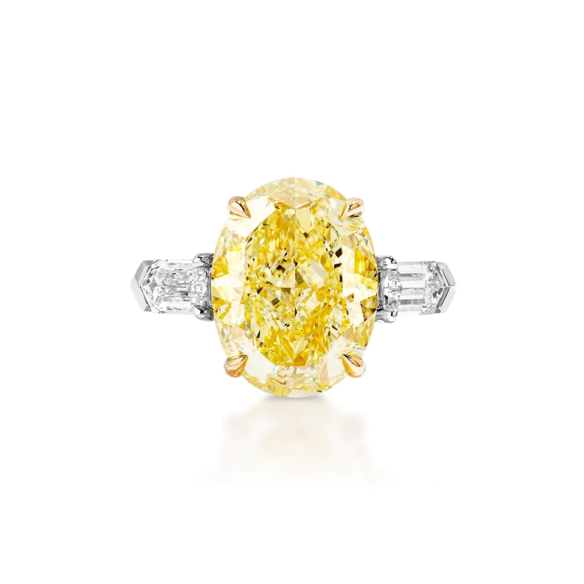 The Fancy Yellow Oval Diamond Engagement Ring with Bullet Side Stones features an oval yellow diamond held in a gold prong setting, accented by rectangular white bullet diamonds on each side and set on a sleek silver band.