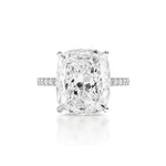A Cushion Cut Diamond Engagement Ring with Pavé Band, featuring a large cushion-cut diamond and a slender, pavé diamond band set in white metal, shown from above against a white background.