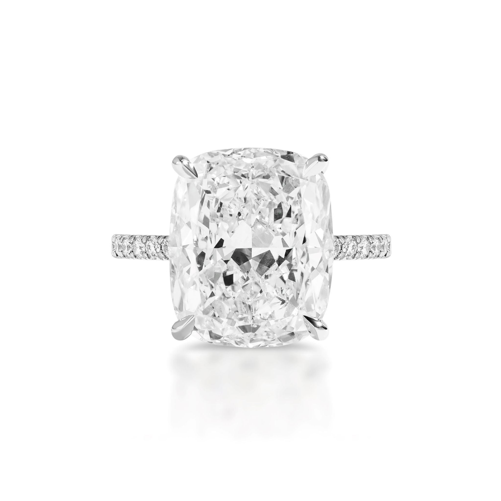 A Cushion Cut Diamond Engagement Ring with Pavé Band, featuring a large cushion-cut diamond and a slender, pavé diamond band set in white metal, shown from above against a white background.