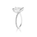 A Cushion Cut Diamond Engagement Ring with Pavé Band, featuring a striking cushion-cut diamond solitaire and a band adorned with sparkling pavé-set diamonds, displayed on a white background—an exquisite celebration ring perfect for marking life’s most cherished moments.