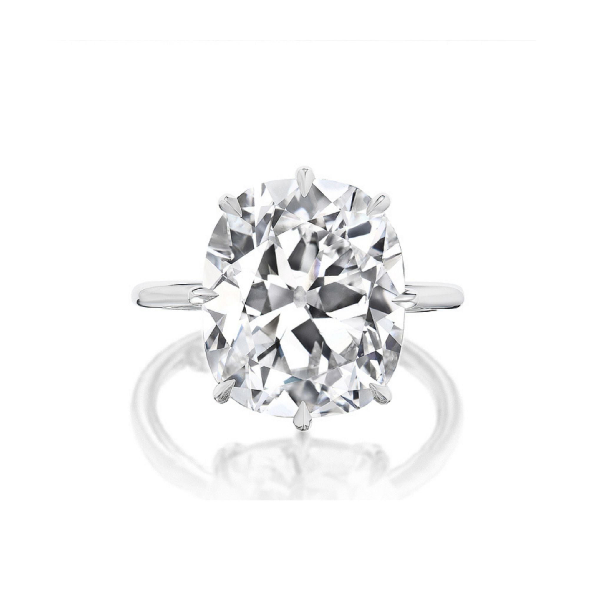 A close-up of the Antique Cushion Cut Diamond Solitaire Engagement Ring, showcasing a large, cushion-cut clear diamond in a prong setting against a plain white background.