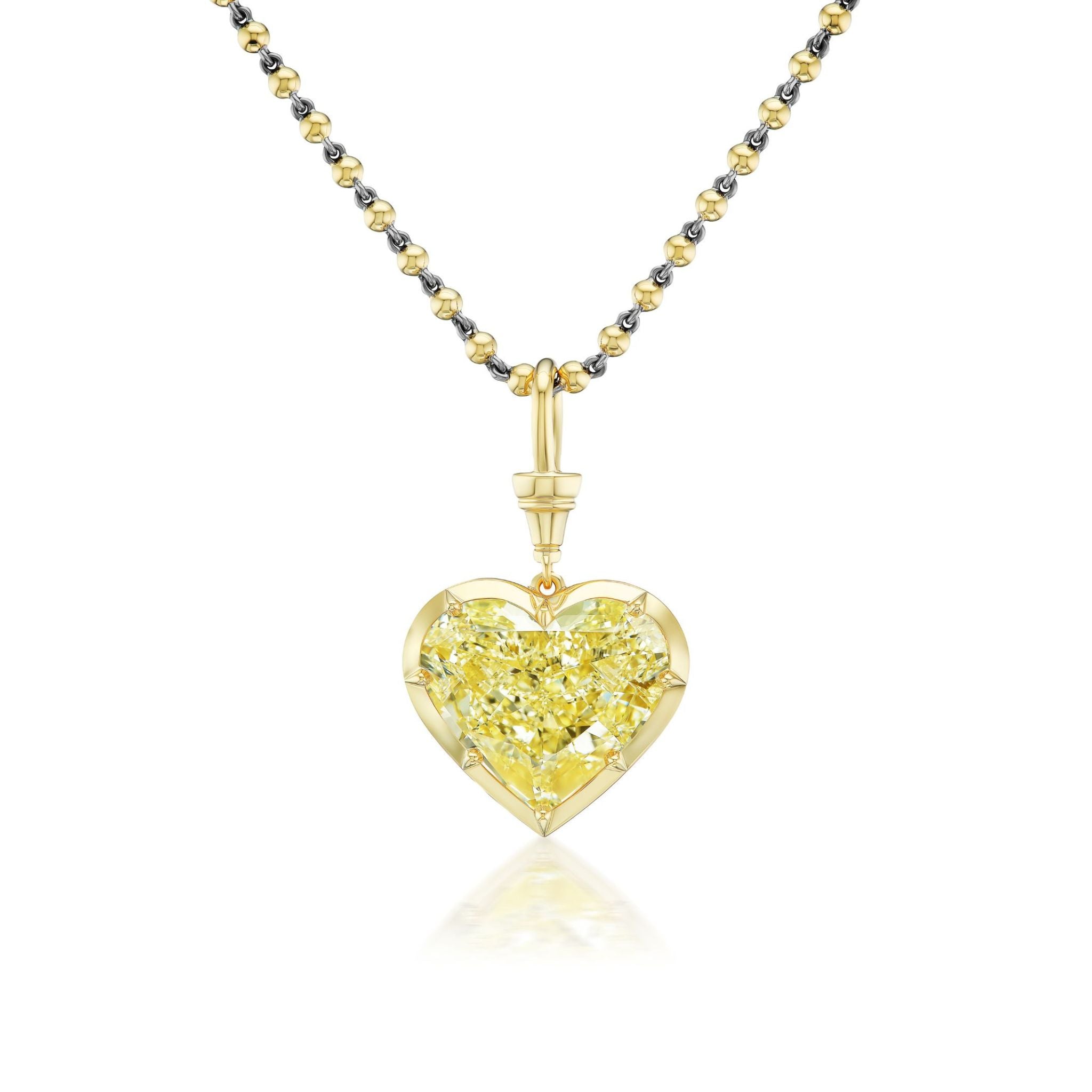Introducing the Collet Set Heart Shape Fancy Yellow Diamond Necklace in Yellow Gold, featuring a chain of alternating gold and silver links, adorned with a striking heart-shaped fancy yellow diamond pendant set in 18k yellow gold and GIA certified for exceptional quality.
