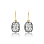 A pair of Collet Set Cushion Cut Diamond Earrings in black rhodium and yellow gold, featuring cushion-cut diamonds set in dark metal prongs, displayed against a white background.