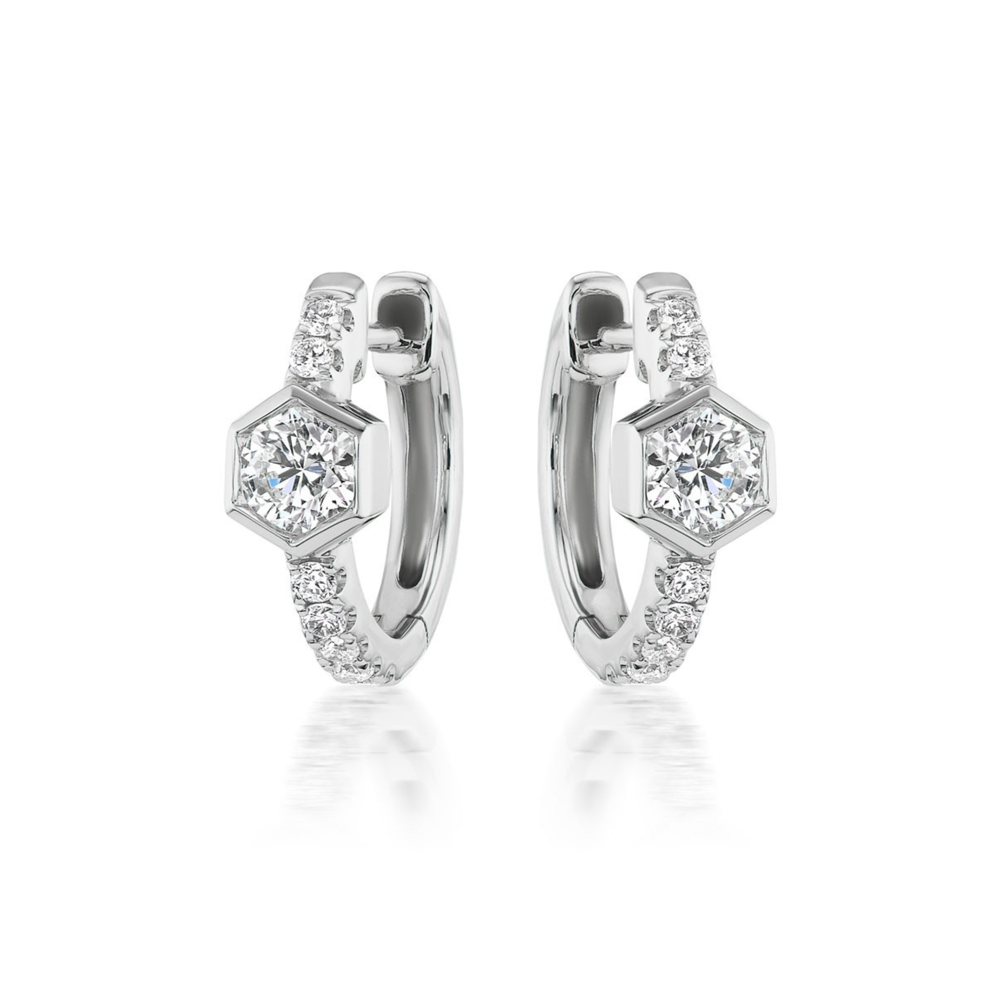 Pavé Huggies with Hexagon Bezel Set Diamonds feature a central hexagon-shaped setting with a round diamond and pavé accents along the front, shown on a white background.